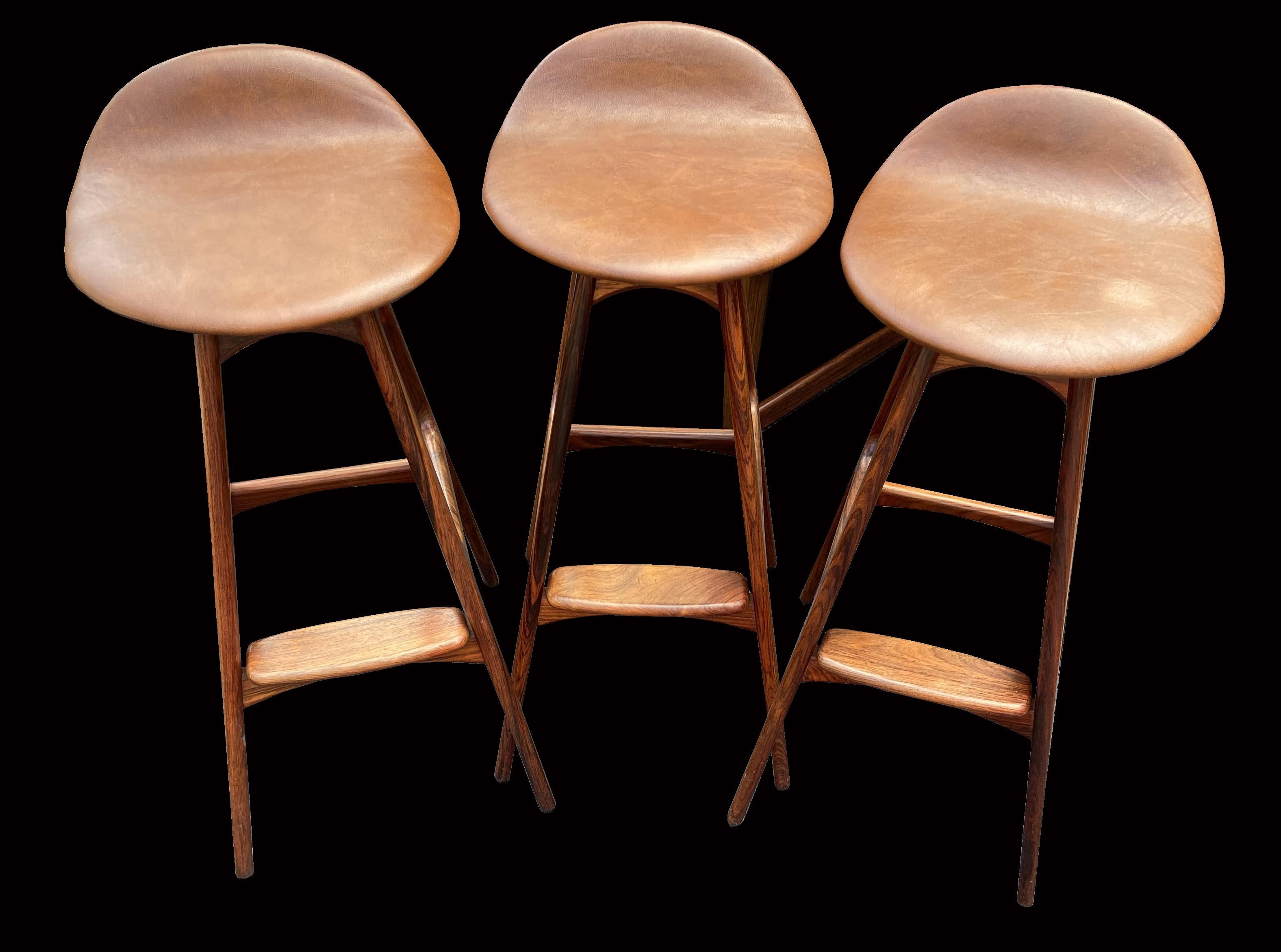 A lovely set of three of these most classic of barstools designed by Erik Buch, or Buck as it is sometimes attributed, produced by O.D. Mobler, these are in Pau Ferro (solid Santos Rosewood ) latin name Machaerium Scleroxylon, and because they are