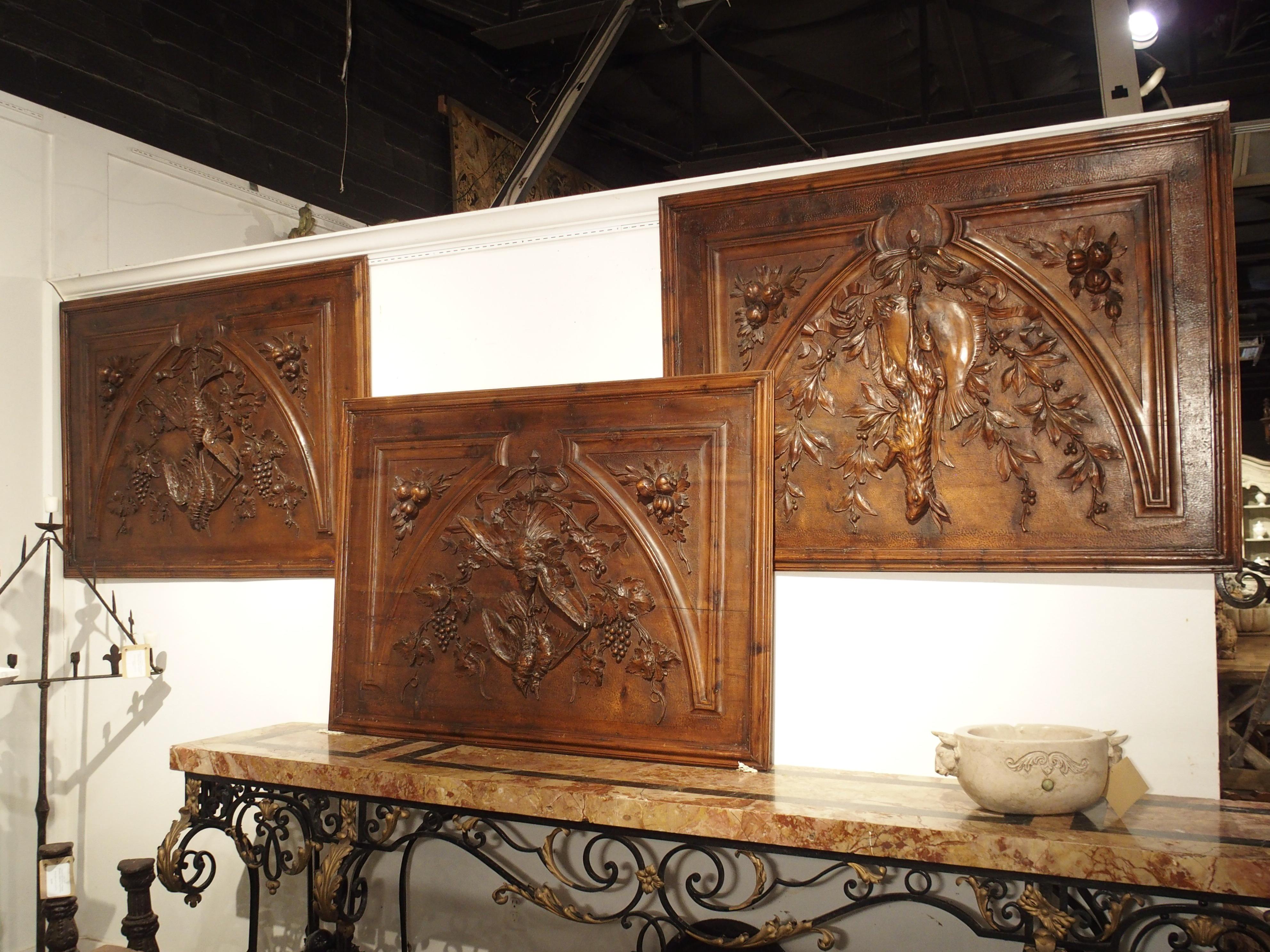 This fantastic set of French panels are decorated with hunting and fishing trophy motifs, all in the Louis XVI style. Two of the panels feature game birds tied from a crinkled ribbon motif with incredibly detailed leaves, stems, and bunches of