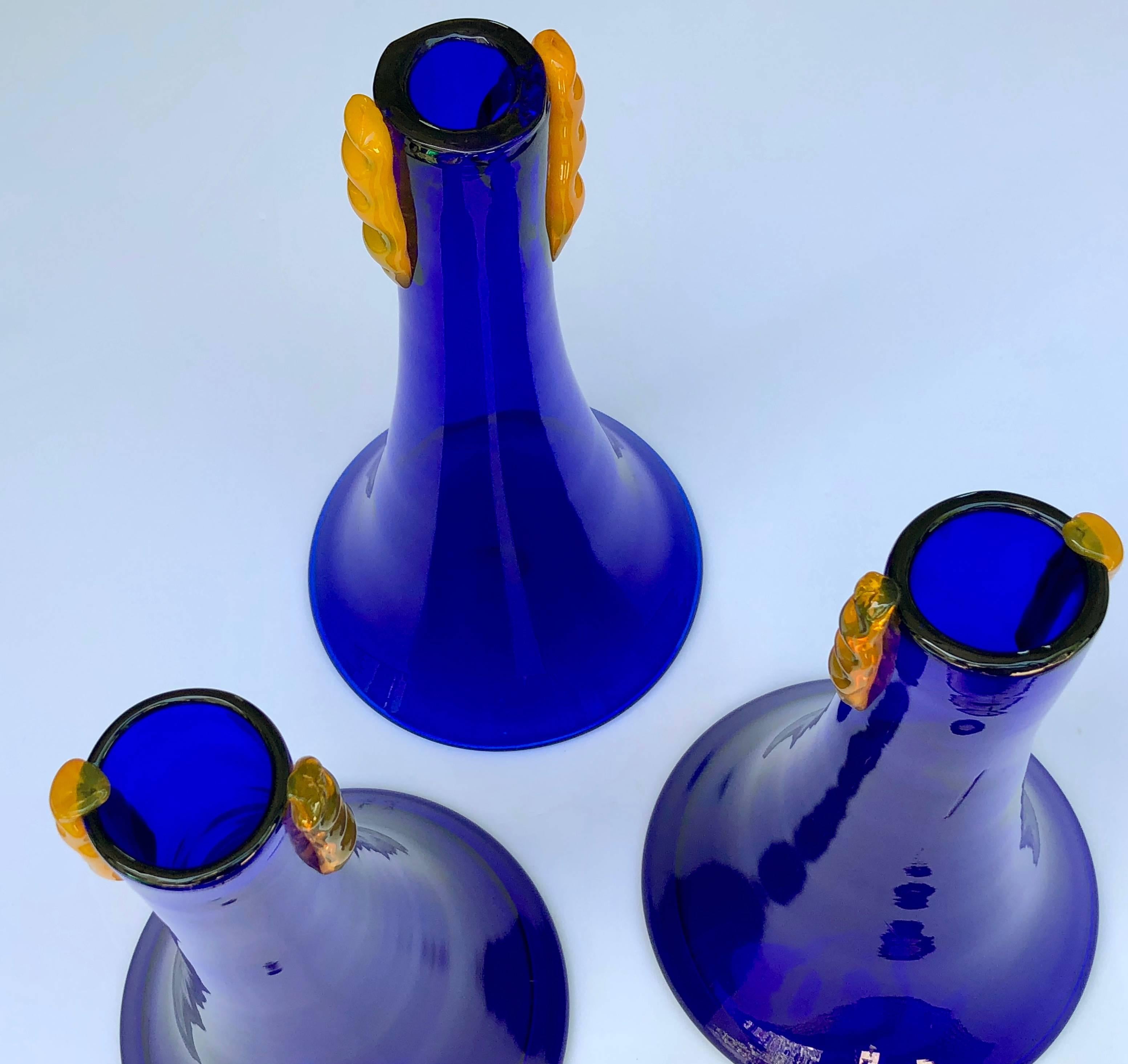 A rare set of three Blenko 1980s cobalt glass flared vases with applied orange decoration; these stylish vases were manufactured by Blenko Glassworks as experimental pieces and were never place into production; of beautiful flared form with applied