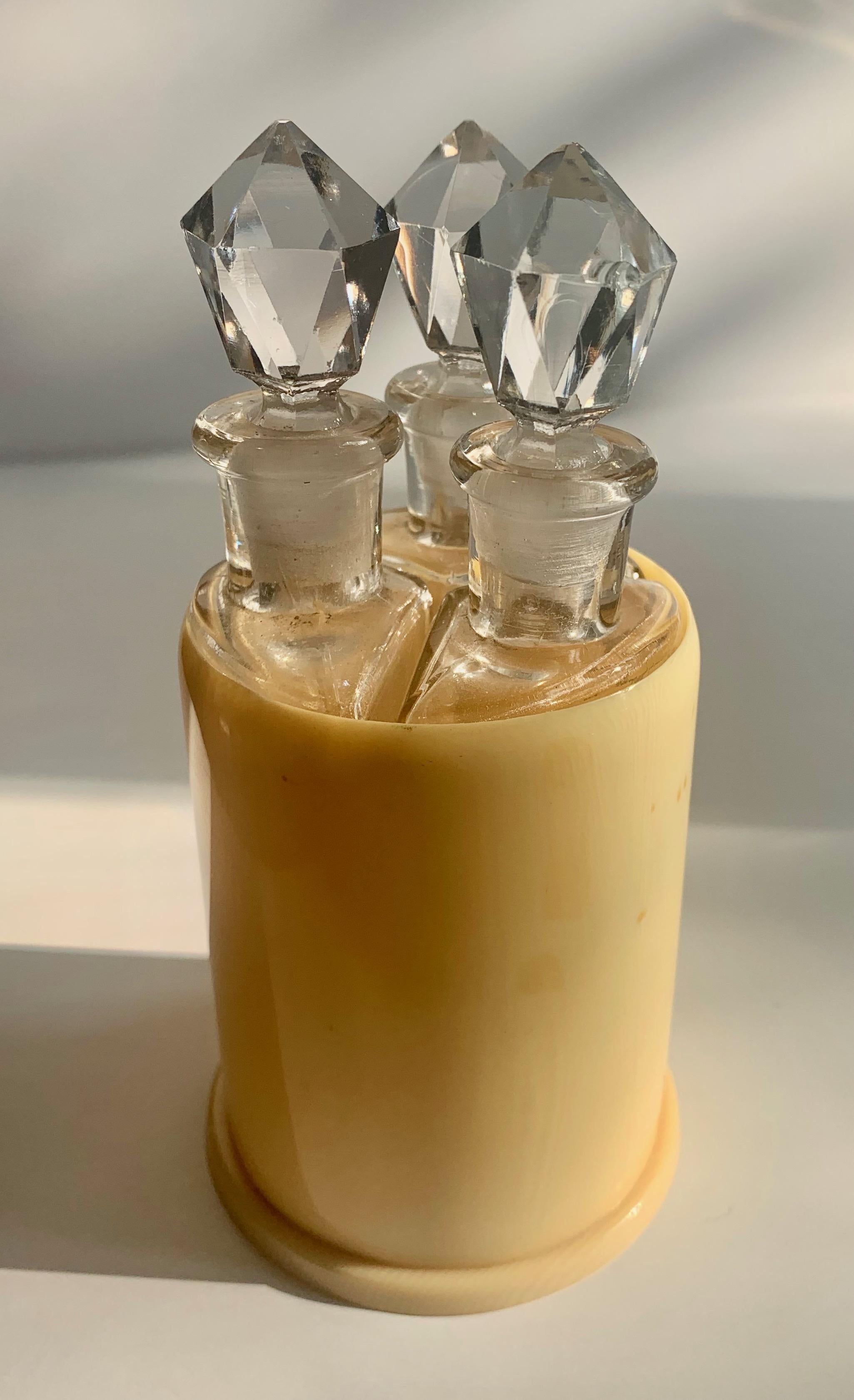 Set of three bottles in holder - three unique triangular shaped bottles with crystal stoppers in round holder. The trio are perfect for perfumes, or as extract holder in the gourmet kitchen.