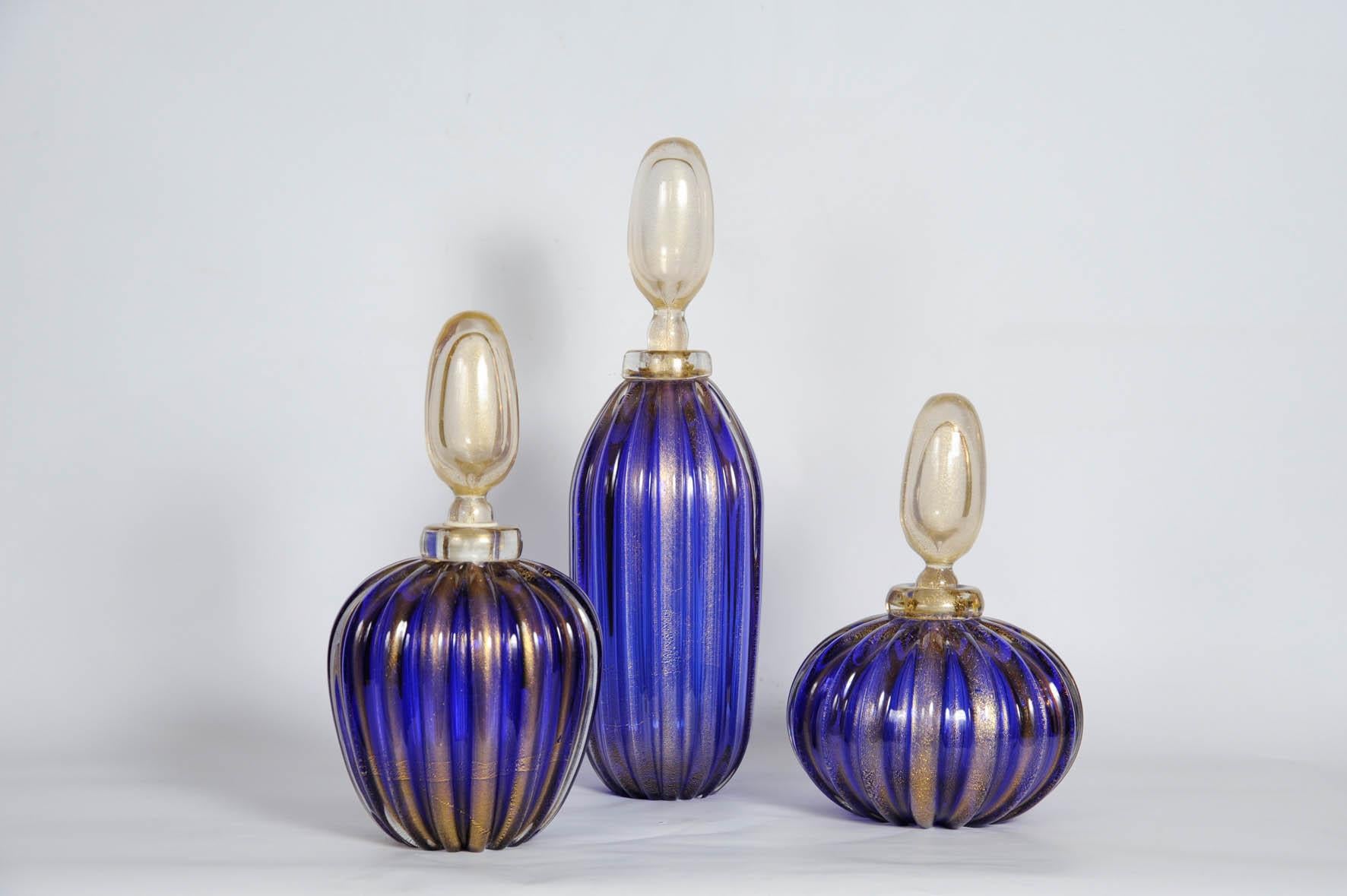 Set of three bottles in Murano glass with height 16, 12, 10 inches.