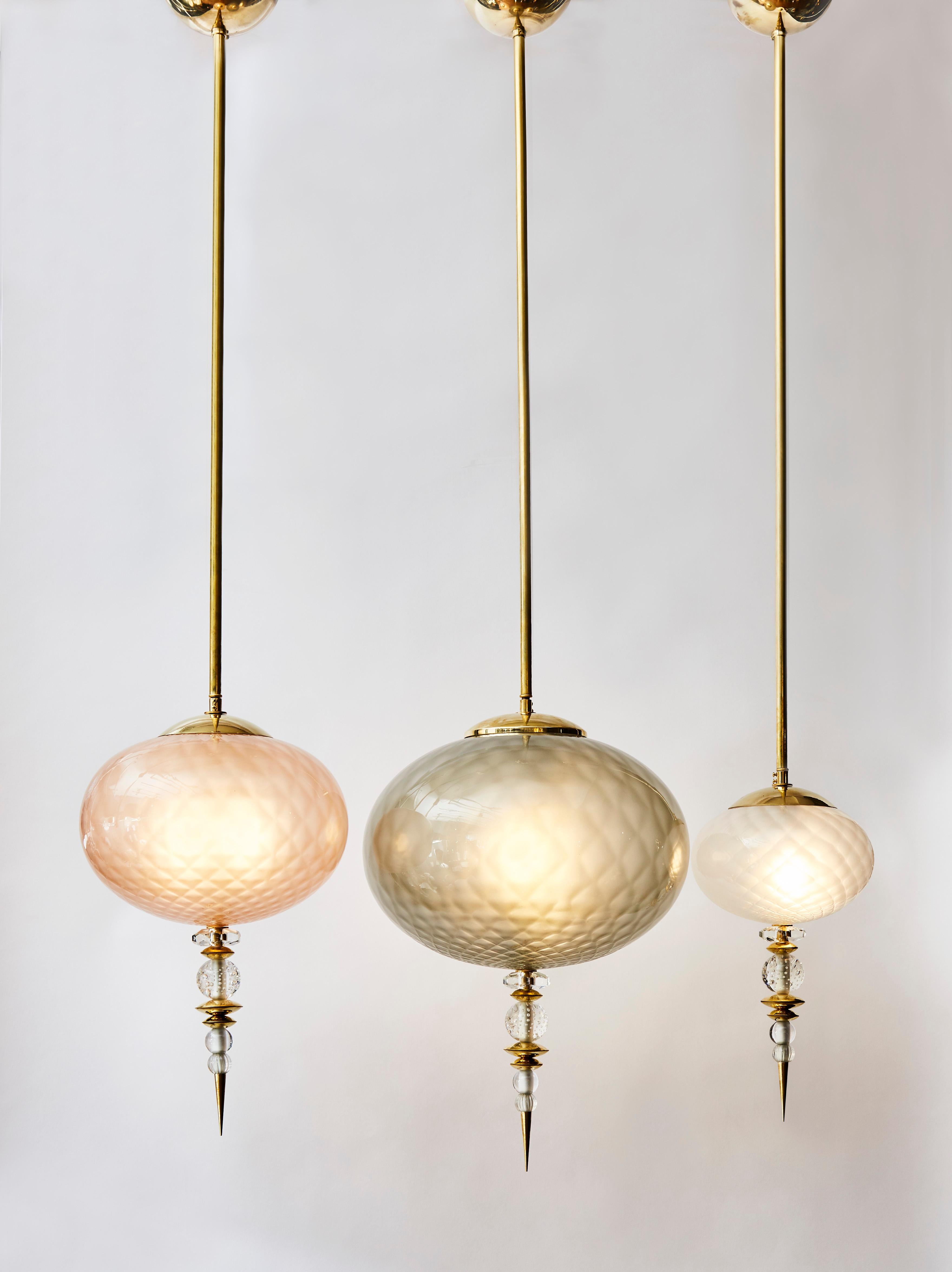 Set of three charming suspensions made of brass structures and different colored Murano glass globes.