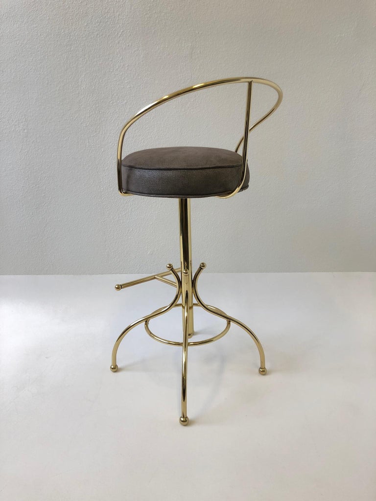 Polished Set of Three Brass and Suede Leather Swivel Barstools by Charles Hollis Jones For Sale