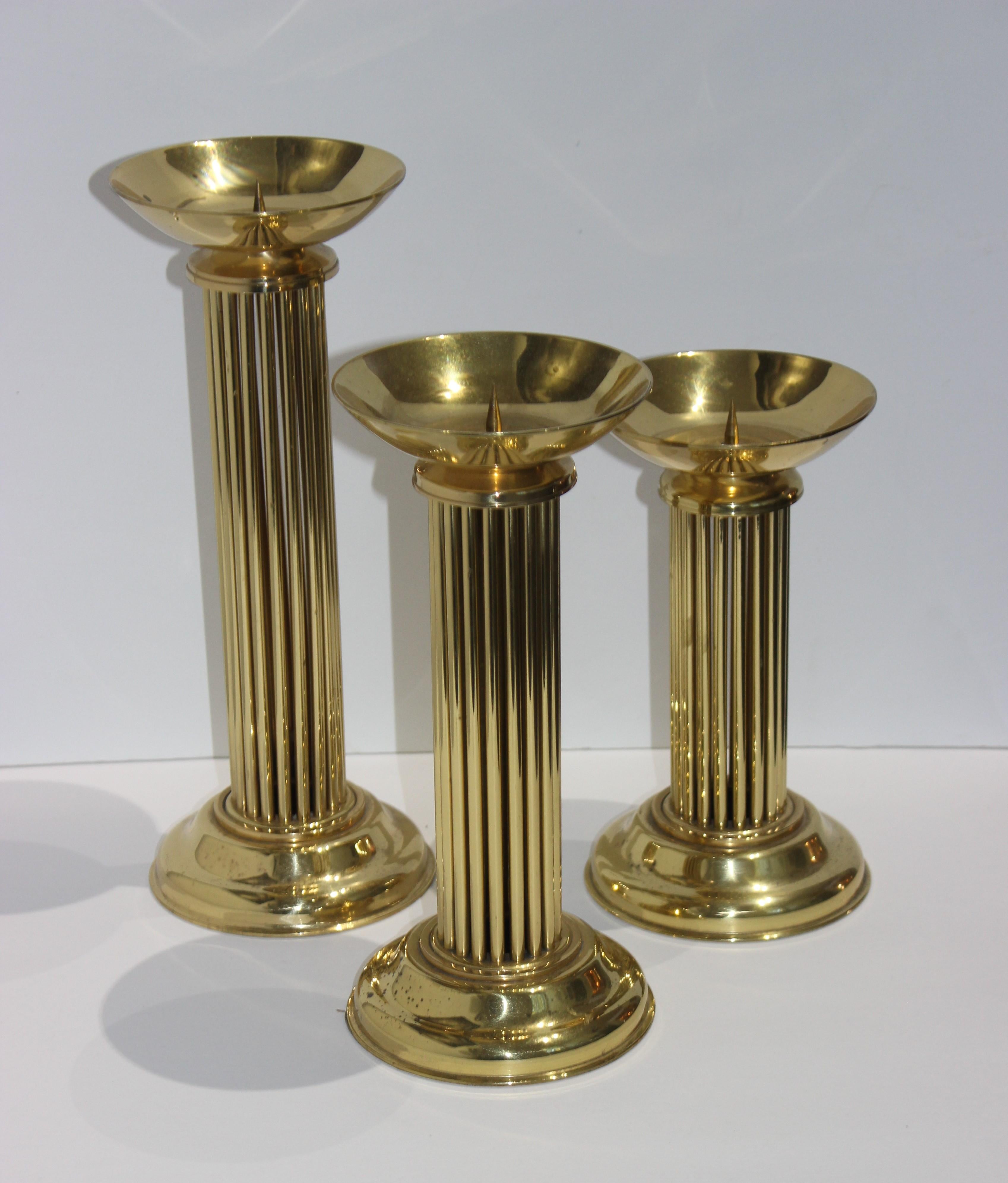 This stylish three-piece set of brass candlesticks have taken their design from a collection created by the American designer Karl Springer and they date to the 1980s.

Note: There is some surface spotting of the bases (see images).

Note: Tallest