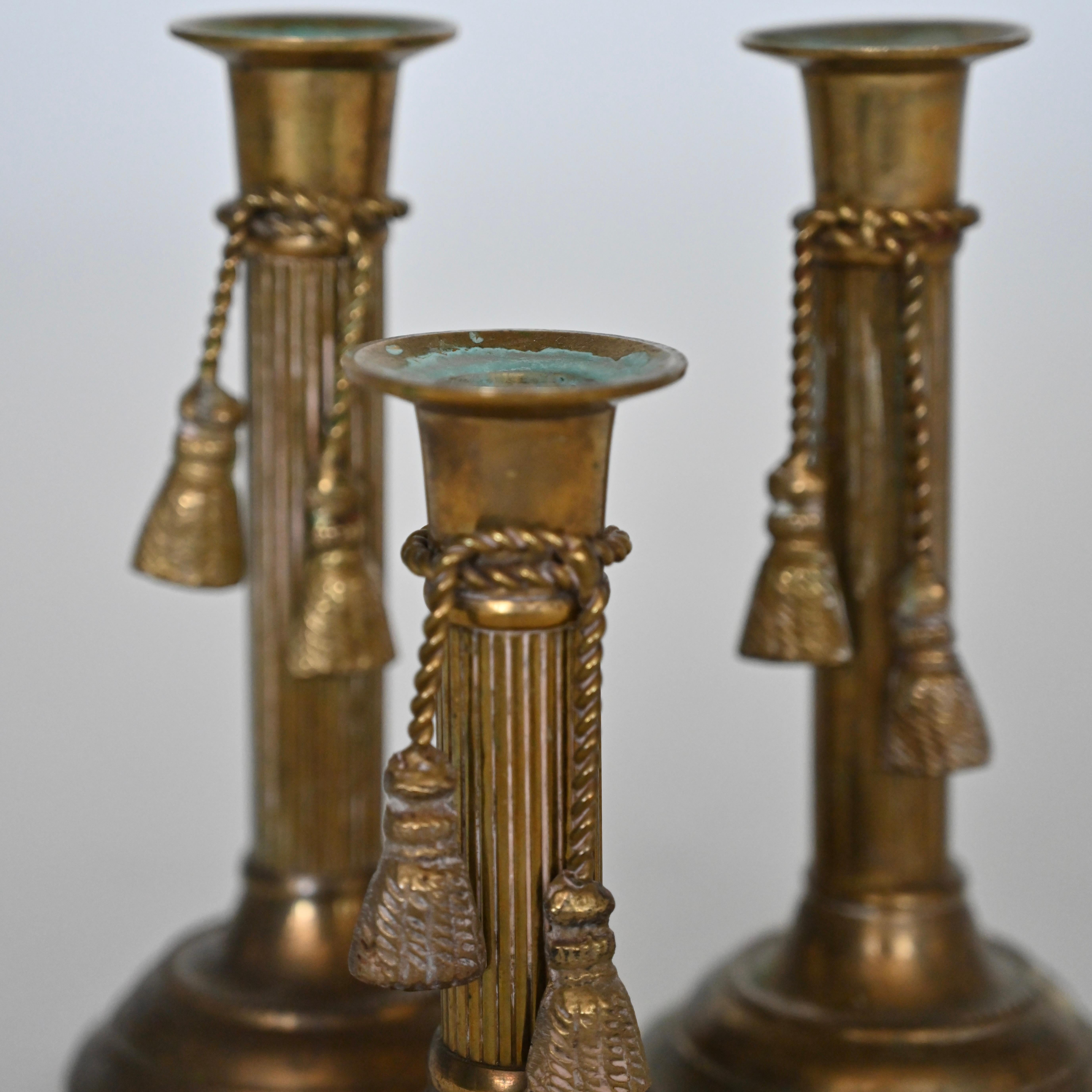 Mid-Century Modern Set of three brass candlesticks with tassel detail, mid 20th century. For Sale