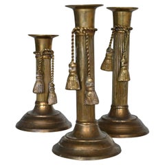 Vintage Set of three brass candlesticks with tassel detail, mid 20th century.