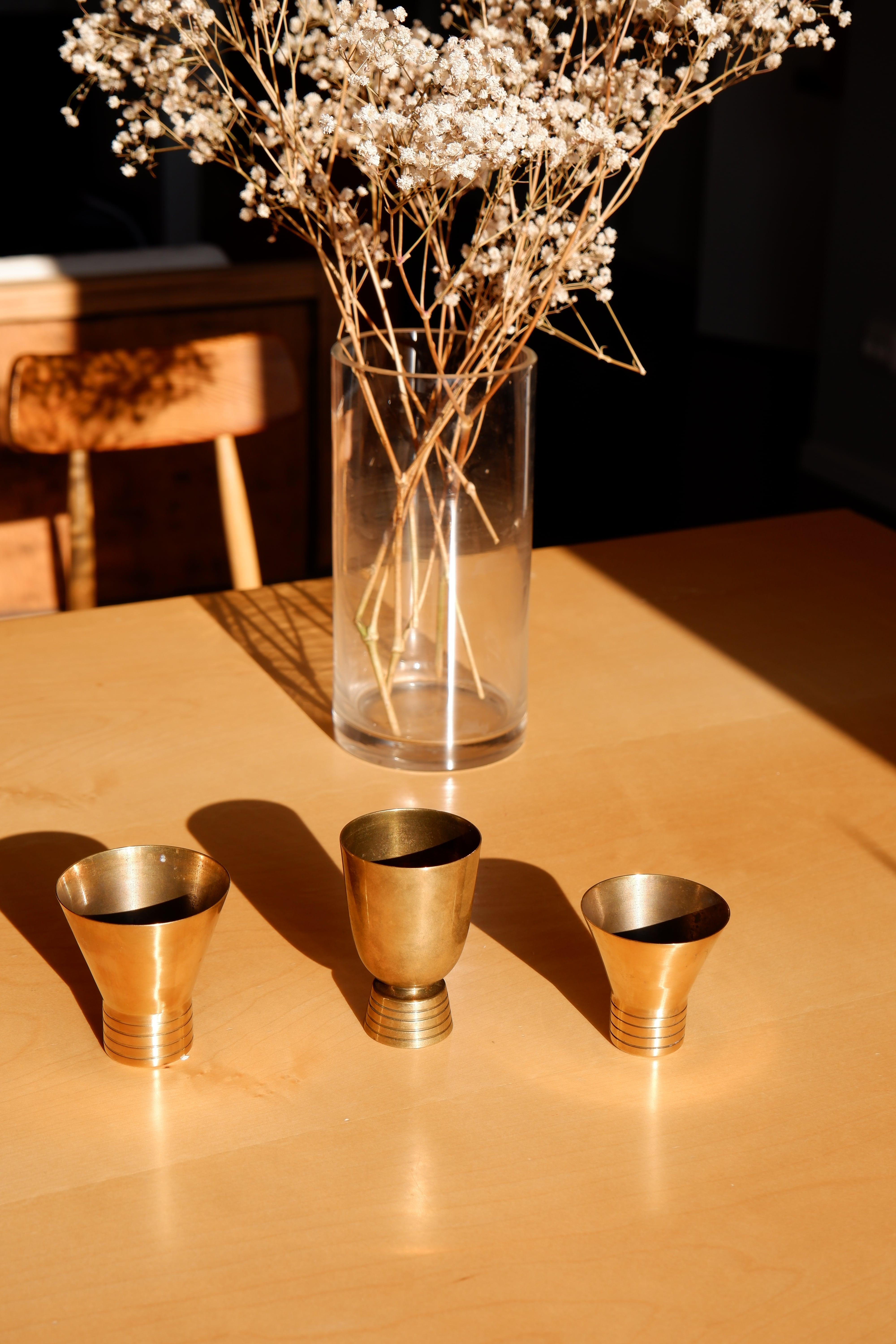 Impressive set of three decorative objects design by Paavo Tynell and produced in the 40's by TAITO OY. The three cups are made in fine layers of brass with decorative details on each of them. The three cups are stamps by the editor TAITO OY.