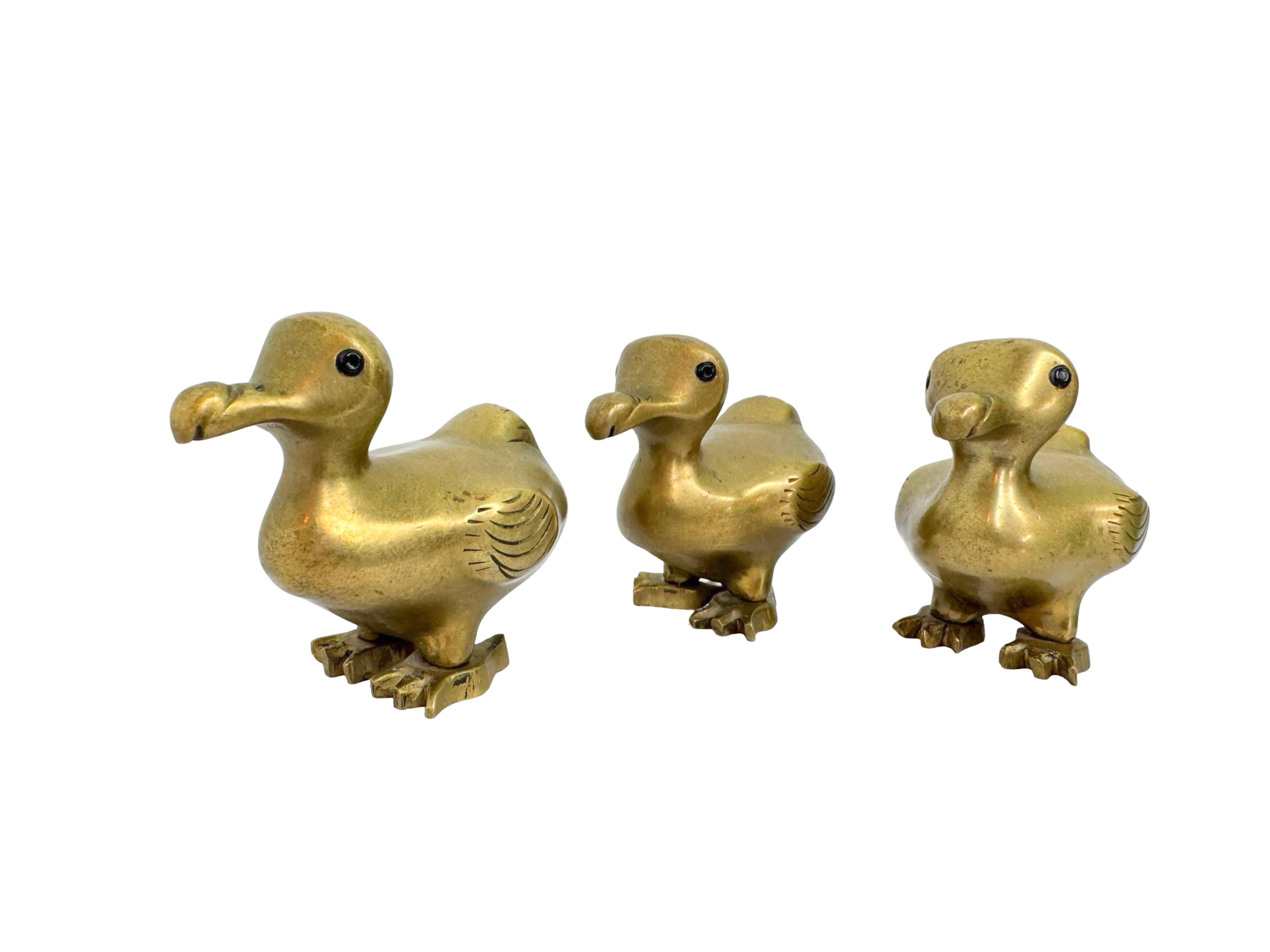 This delightful set of three vintage brass dodo bird figurines dates to the 1960s and was discovered at an estate sale in Berlin, Germany. Each figure represents the iconic, flightless, and now-extinct dodo, rendered with whimsical charm and plenty