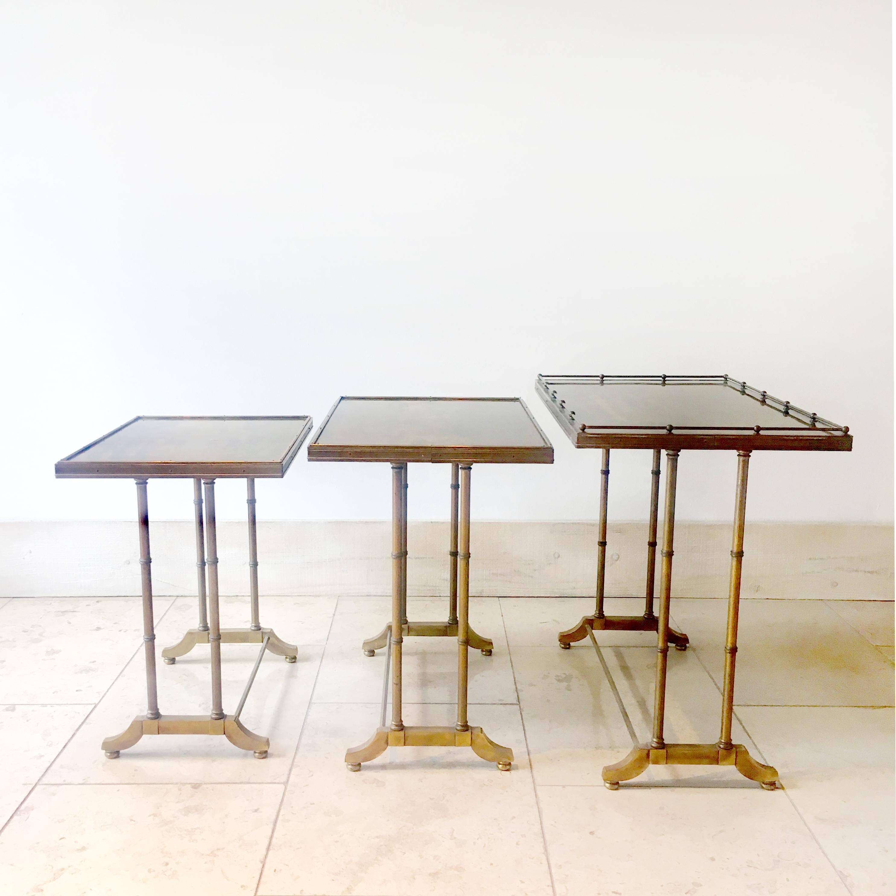 Set of three nesting tables made of faux bamboo with tray type tops with brass bars, trims and pull details, 1960s.
 