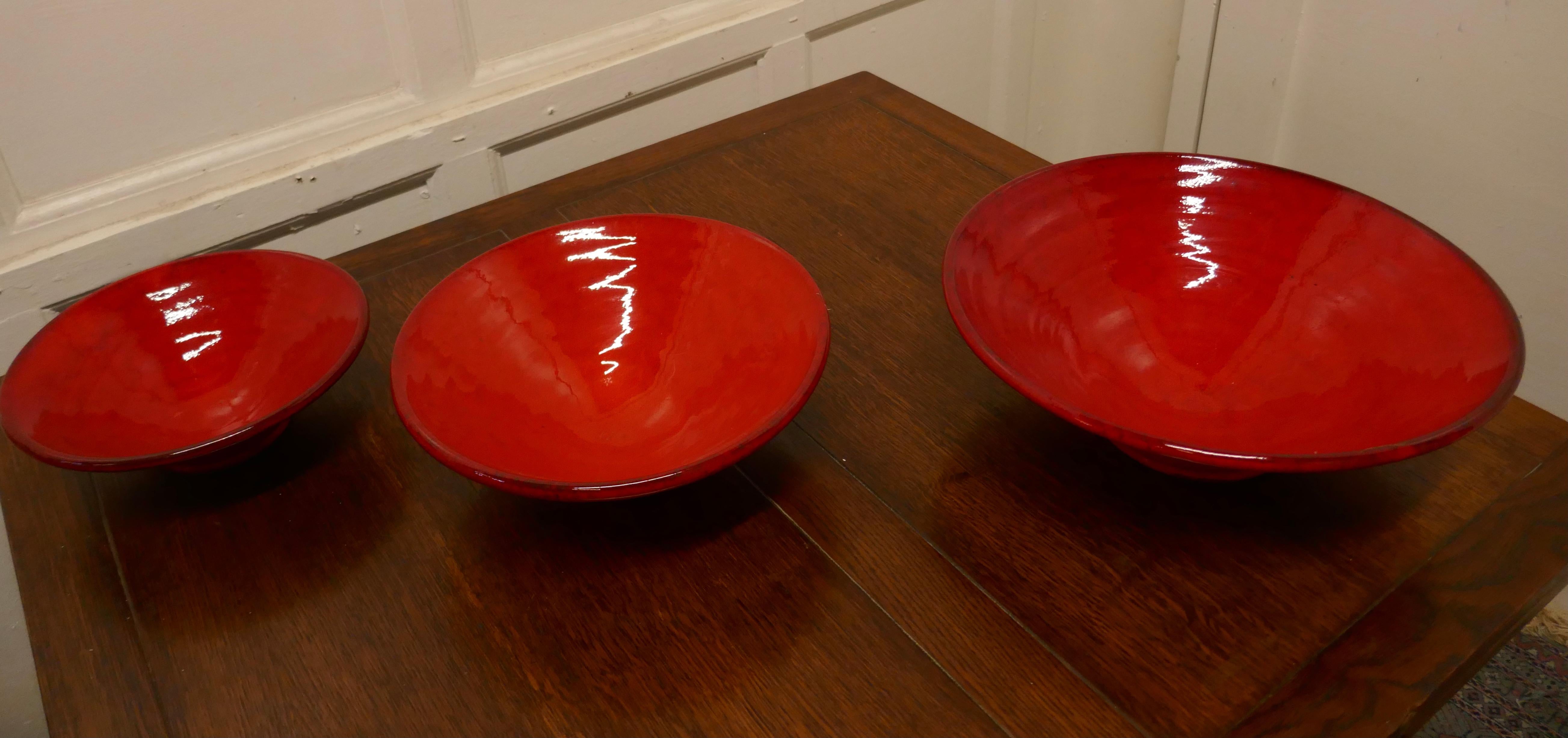 Set of Three Bright Red Terracotta Dutch bowls

A wonderful bright coloured set made in glazed terracotta in the Dutch style, in very good condition, the largest bowl is 5” high and 15” in diameter 
TNV123.