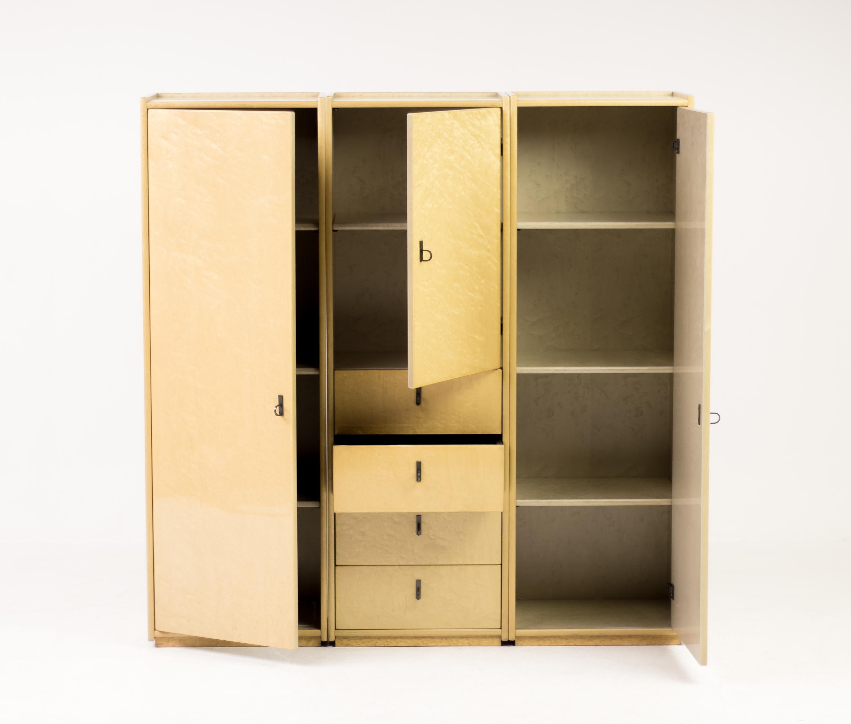Spectacular bird's-eye maple cabinets by Saporiti Italia.
The gloss finish and sleek profile make these cabinets stand out in any setting.
With seven shelves and four roomy drawers the three cabinets feature ample storage space.
 