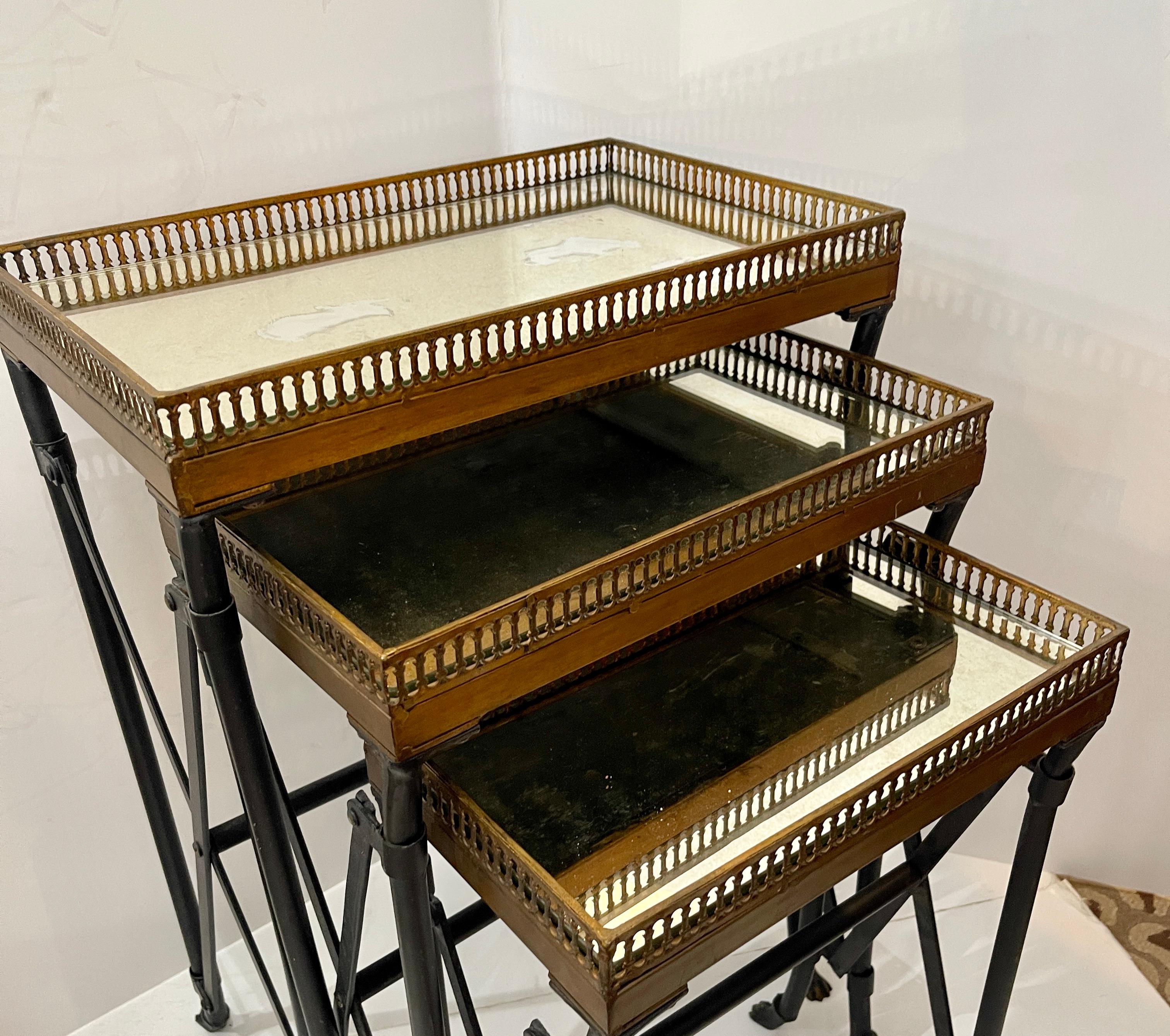 Just in, this Set of Three Mirrored Top Bronzed Campaign Gallery Nesting Table.
Each have a gallery ,  old mirror and paw feet.
These are very heavy and sturdy the basses are in the campaign style, they do not fold.
Very good vintage condition,