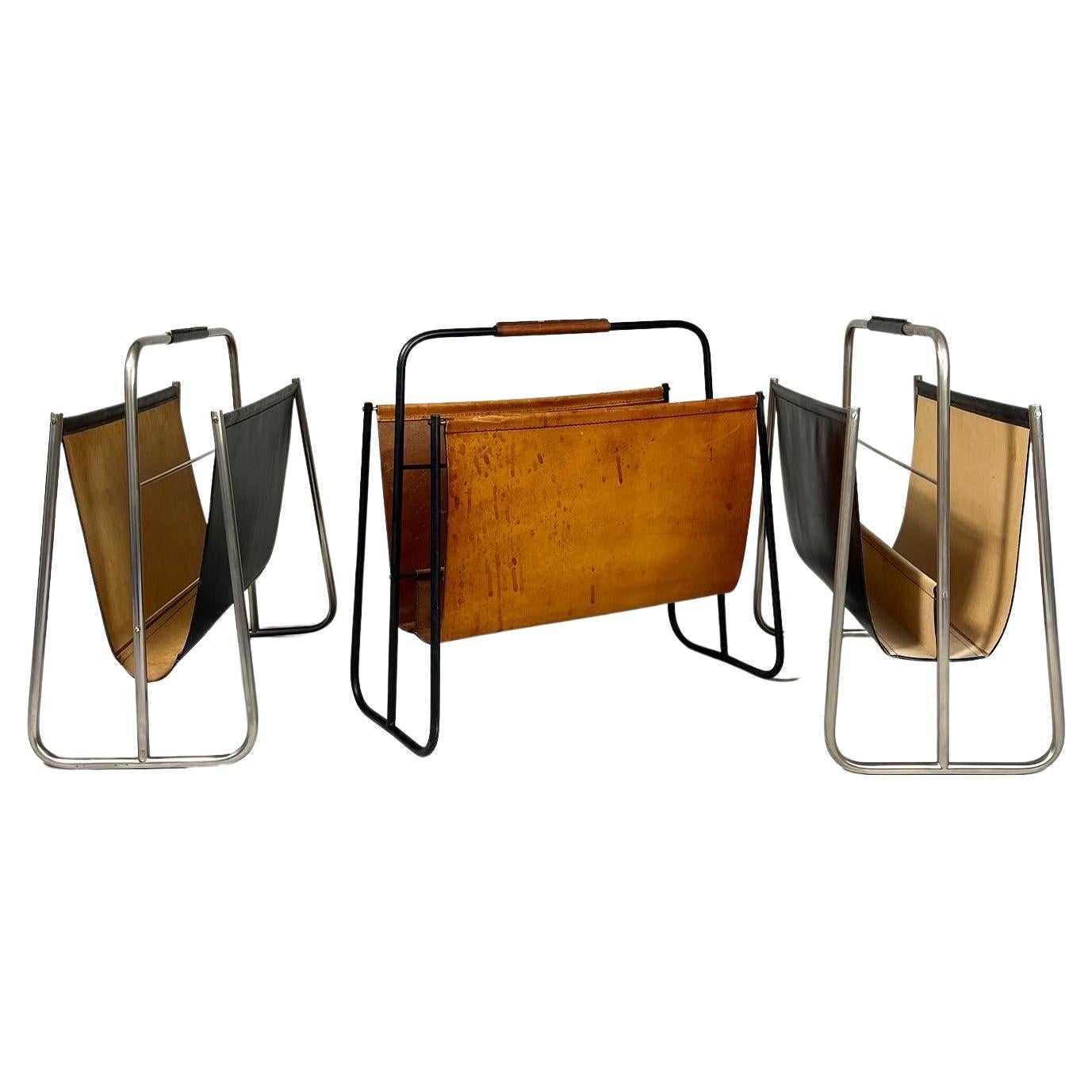 Collection of three Carl Auböck magazine racks with nickel plated & blackened frames, stitched leather, hand crafted by the Auböck workshop in Vienna, Austria in the 1950s. 

Width: 46 cm
Depth: 25 cm
Height: 44 cm

From left to right first