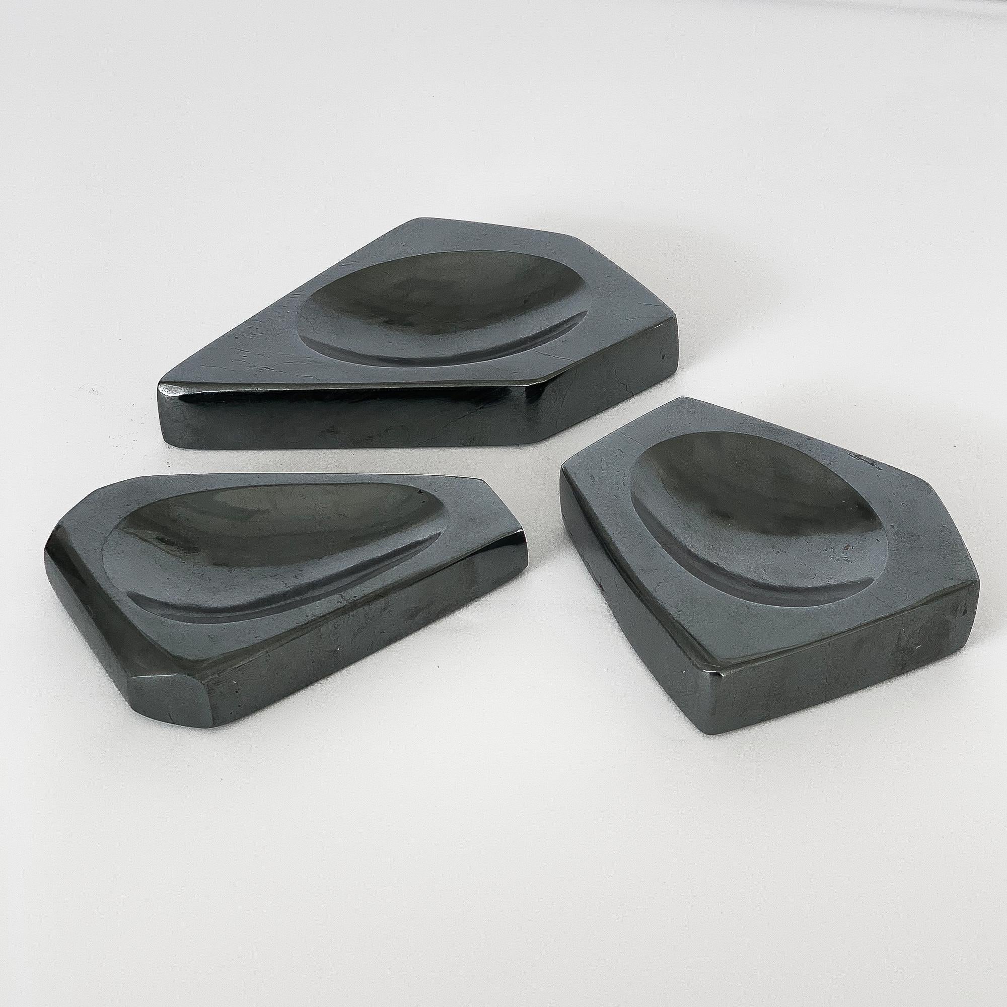 Set of three carved hematite stone vide poches or dishes. Faceted carved solid hematite stone with elliptical shallow 0.5