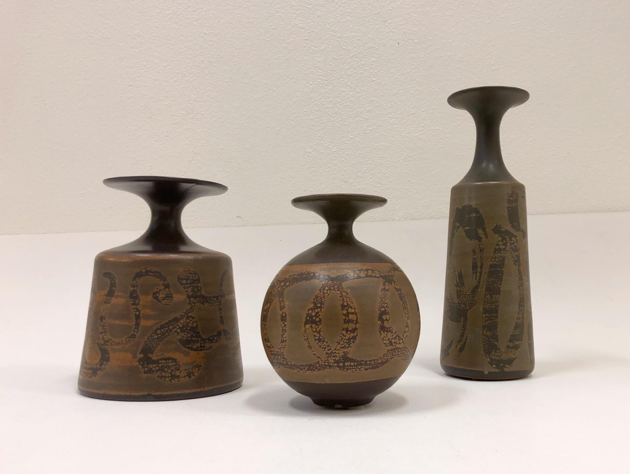 A set of three large ceramic vases designed by Robert Maxwell for Designs West of California in the 1970s.

Measures: Tallest- 16.75” high 5.5” diameter.
 Medium- 11” high 8.5” diameter.
 Small- 10” high 8” diameter.

 