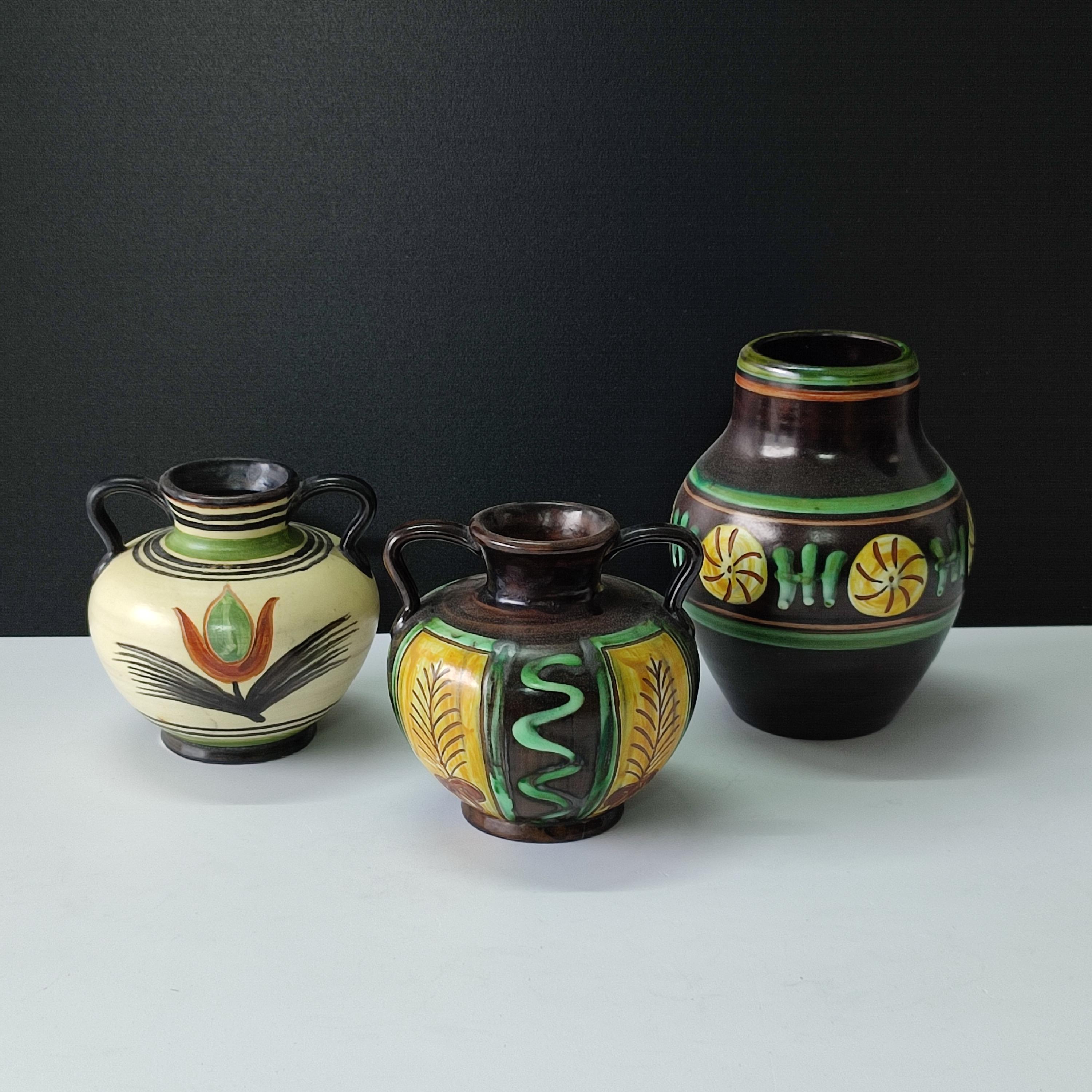 A set of Upsala Ekeby pottery vases with polychrome glaze, 1936-1938.
Each marked with maker's mark to the bottom.
Dimensions:
1. Vase with handles signed EKEBY, monogram H.A and numbered 3201
height 13 cm, diameter 12 cm.
2. Vase signed EKEBY,