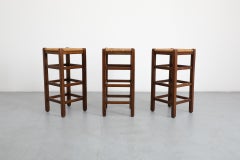Set of Three Charlotte Perriand Style Dark Stained Oak and Rush Bar Stools