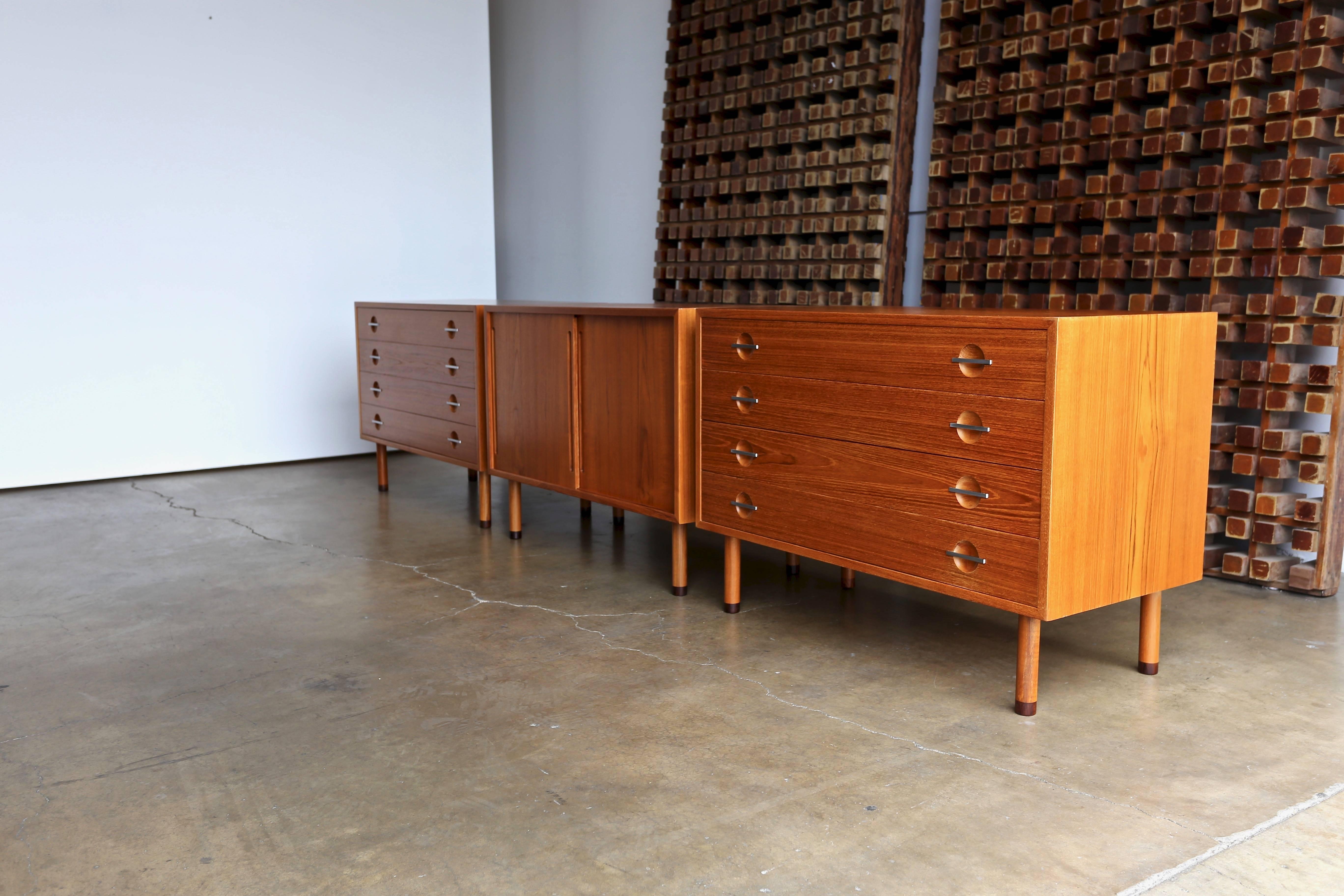 Three teak chest by Hans Wegner for Ry Mobler Denmark, circa 1960.

This set is finished on the back and can be configured to best meet the customers needs. 

Each chest measures: 39 3/8