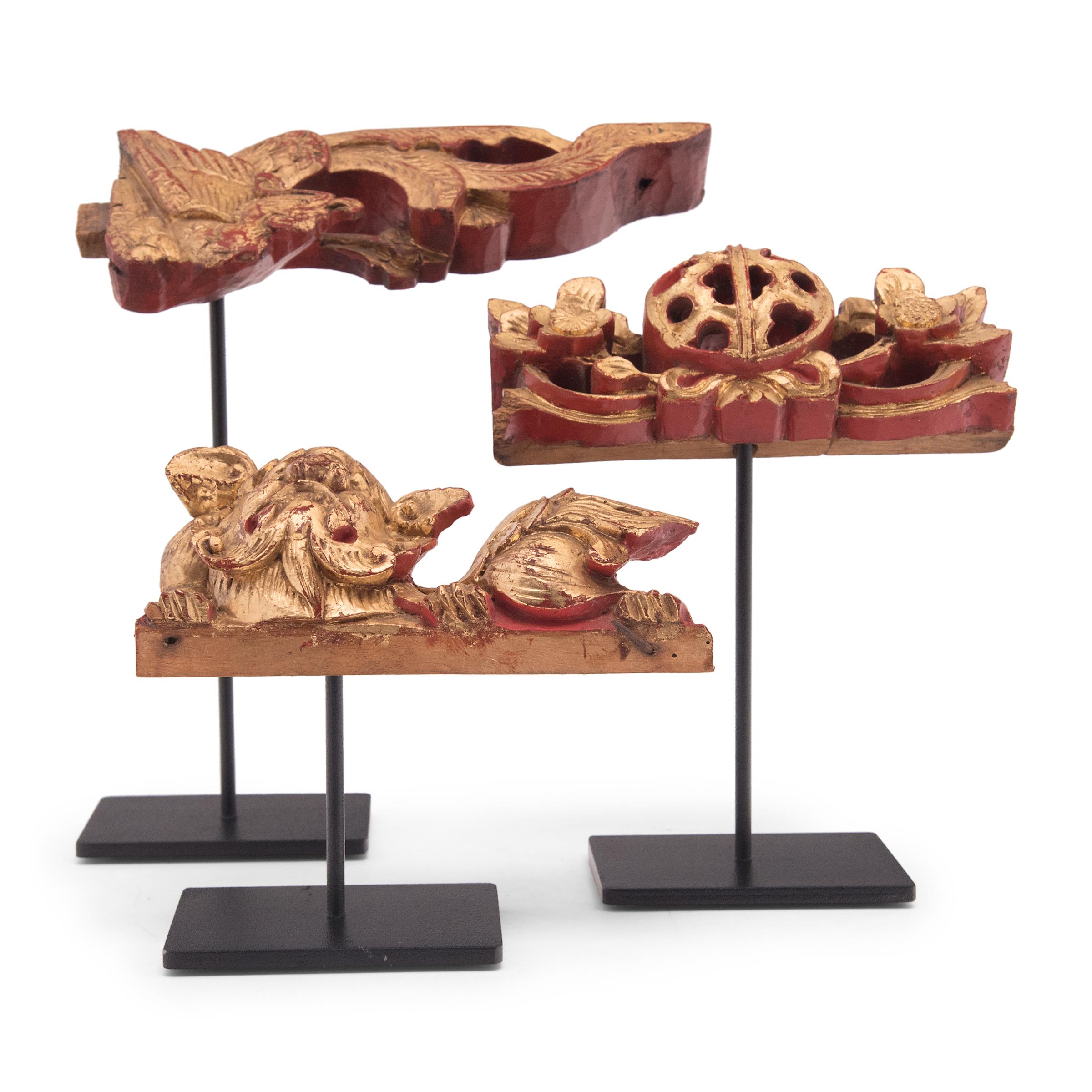Hand-carved and lavishly pigmented, these gilt fragments originated as decorative elements of ornate Qing-dynasty furniture or architecture. Elevated by custom steel display mounts, each fragment is carved to a different mythical form - a fu dog