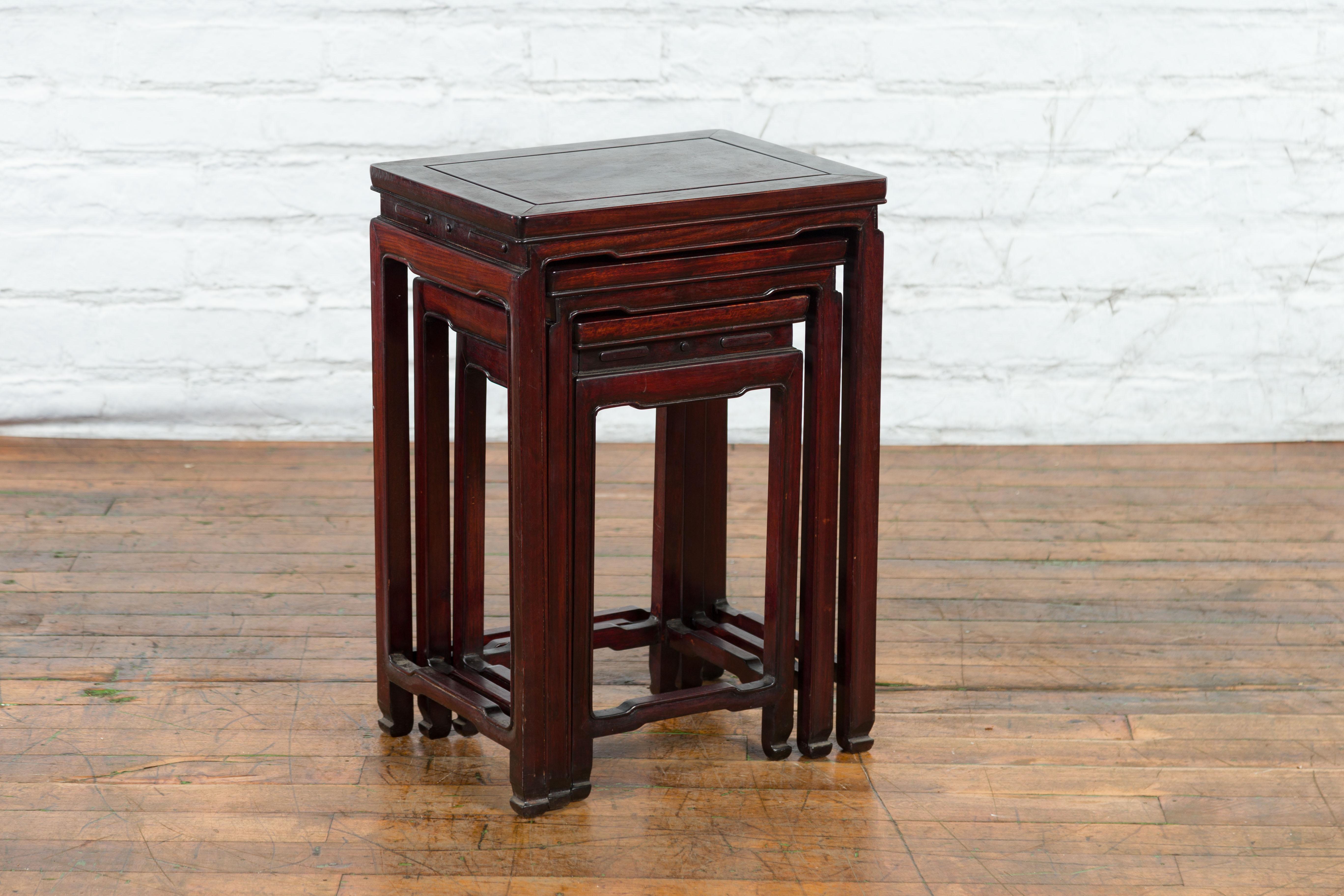 Carved Set of Three Chinese Vintage Rosewood Nesting Tables with Reddish Brown Patina For Sale