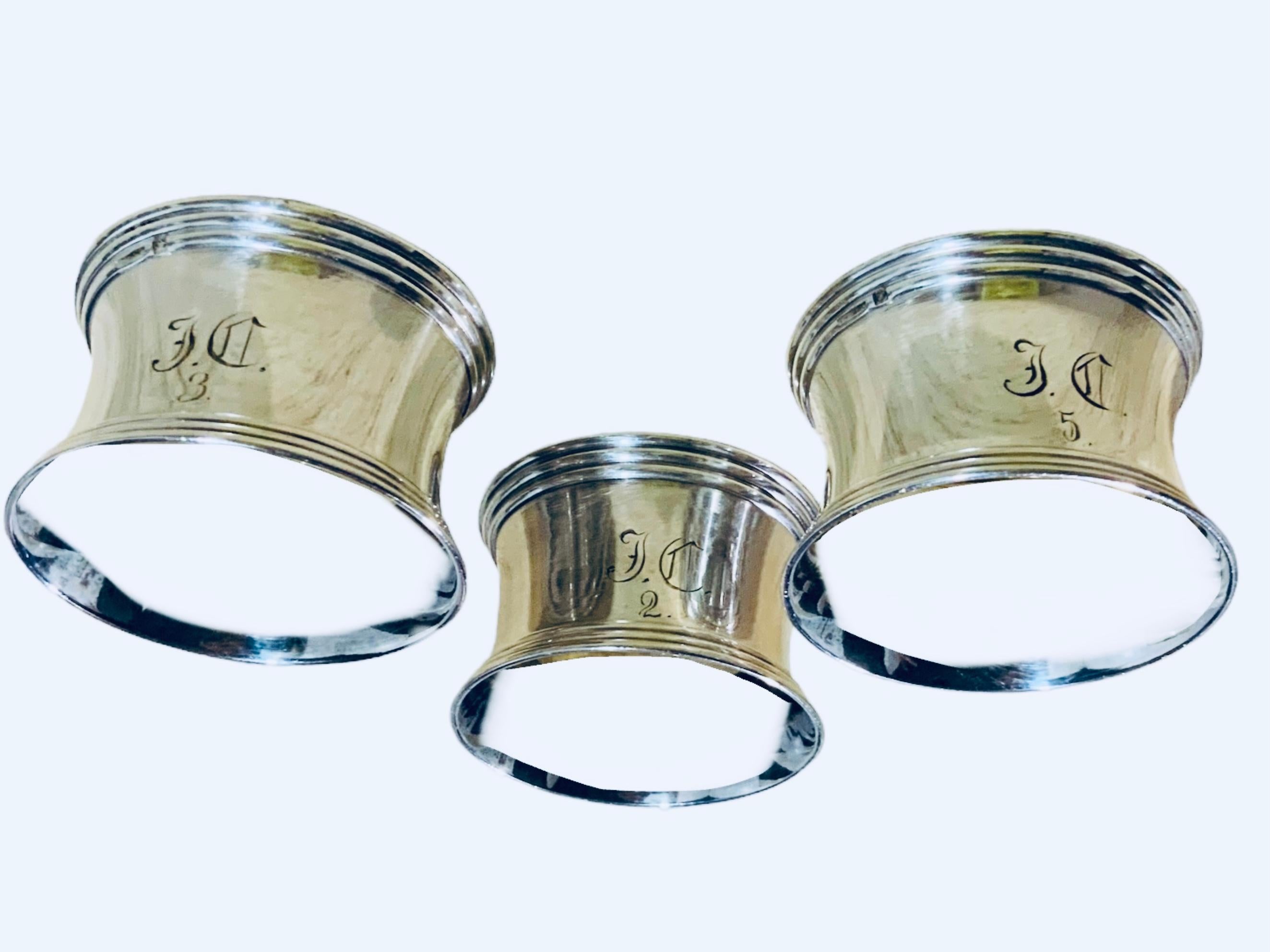This is a set of three Christofle Silver Plate Napkin’s Rings. It depicts a wide concave shaped rings engraved in the center with the monogram of the gothic letters “J and C” and also the numbers 2, 3 and 5. The rings are adorned with reeded borders