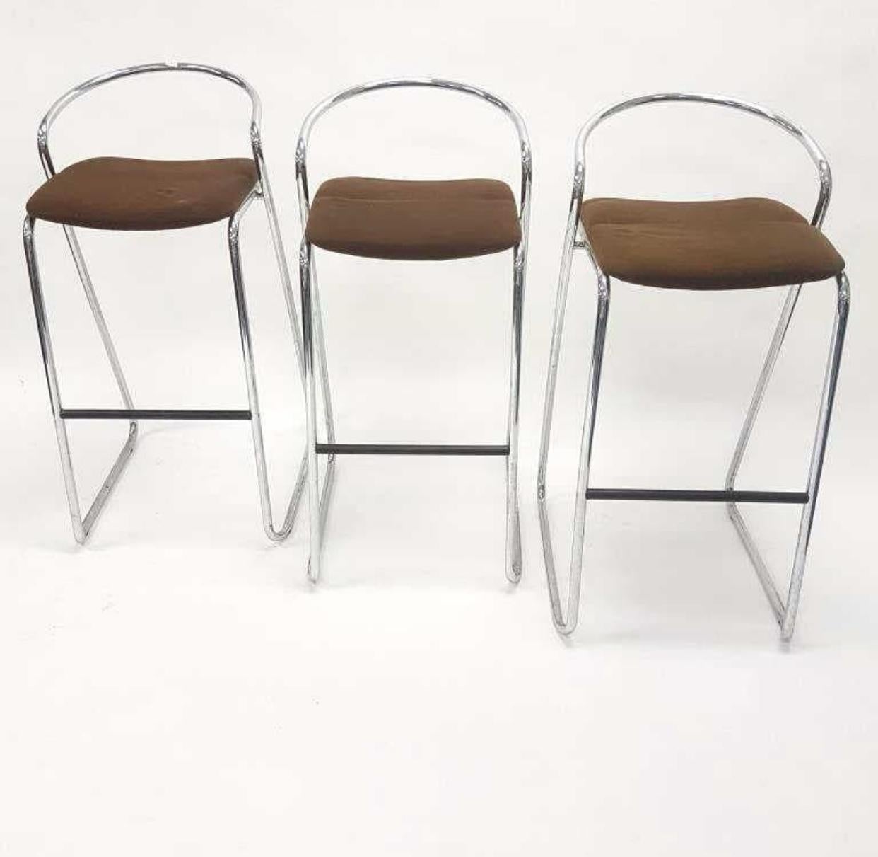 Set of three minimalist barstools by Hank Lowenstein, manufactured in Italy. The barstools are made of chromed steel bars and wool upholstered seats. The padding of the seats is slightly dented. It can either be replaced or steamed to bring it back