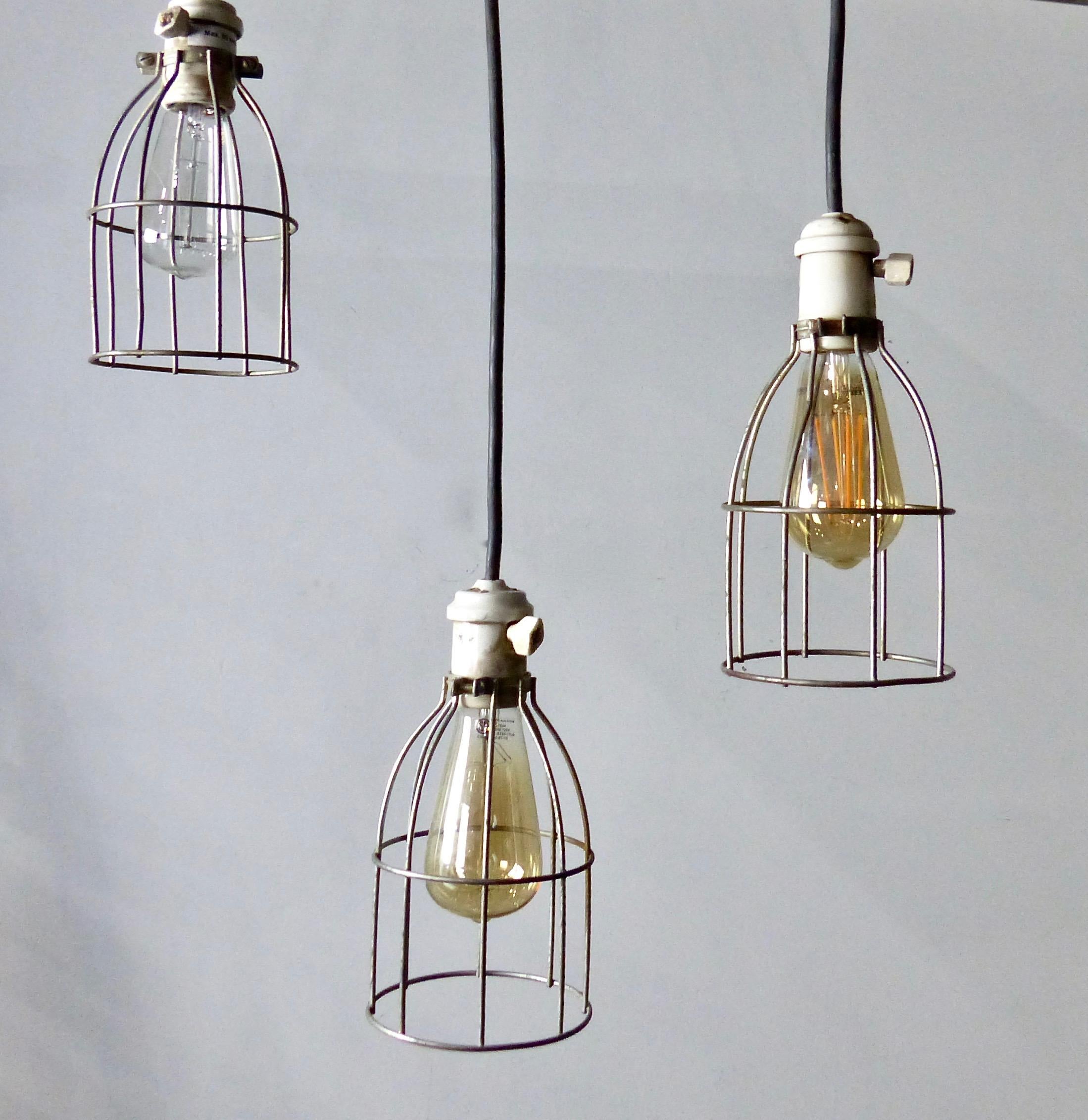 Simple but striking industrial caged lights. This set of three authentic, circa 1930s pendants feature ceramic housings. Re-wired and CSA approved to current electrical standards. Price per light.
Dimensions: 10” height x 5” diameter.