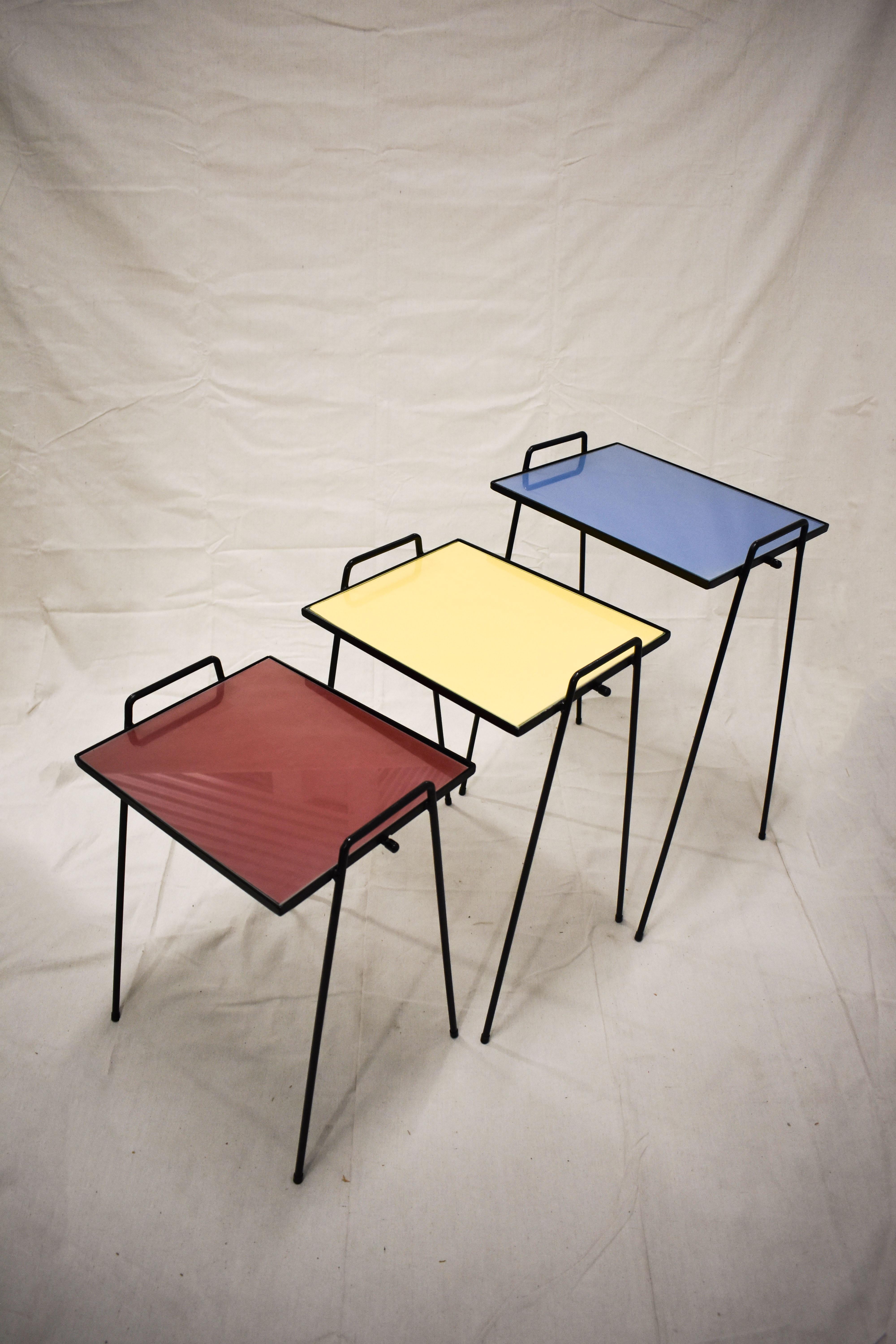These cute, mid-century colorful nesting tables are ready for your next groovy cocktail party.  They conveniently stack to take up minimal space but then come out to make a colorful statement at any party.  The iron frames have been repainted and