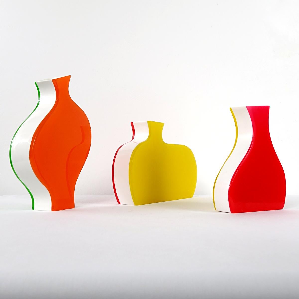 This cheerful trio of vases were produced by Villeroy & Boch. They each consist of three colors. There is a combination of red, white and green and there are two combinations of red, white and yellow. 
Due to the playful Barbapapa like shapes each