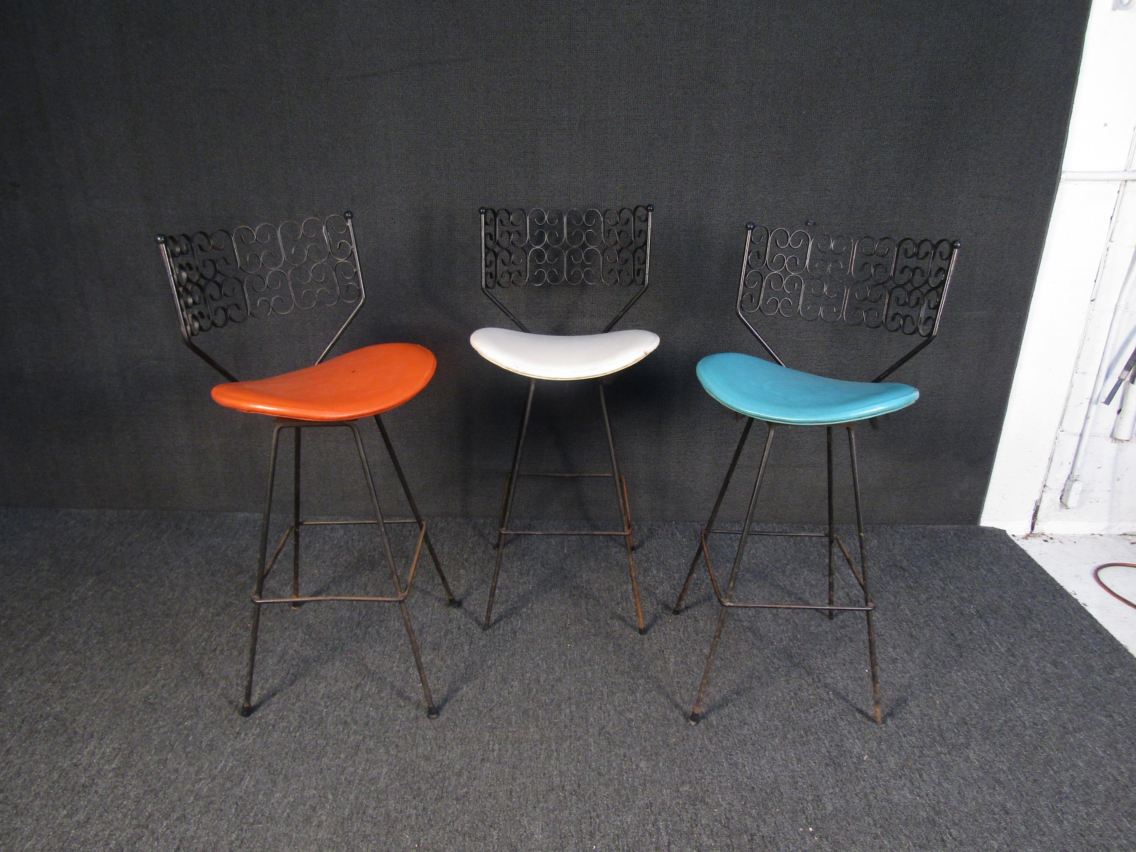 With contrasting colors of vinyl seat coverings, these vintage stools feature metal backs with playful decorative patterns. Made by Arthur Umanoff for Shaver Howard.
Please confirm item location with seller (NY/NJ).