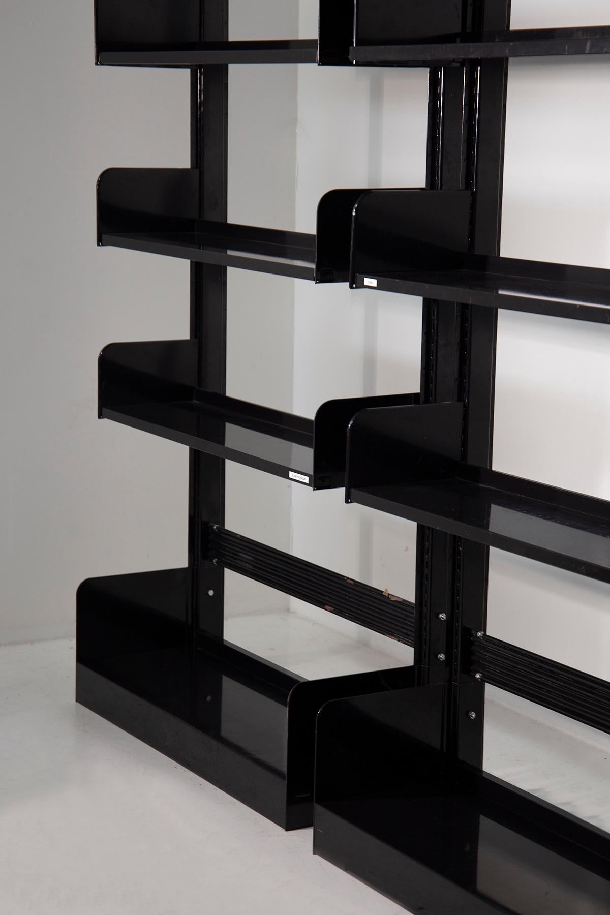 The trio of black Congress bookshelves by Lips Vago from the 1960s exudes an aura of timeless sophistication and functional elegance. These bookshelves, crafted from sleek black-painted metal, stand as iconic symbols of design ingenuity and