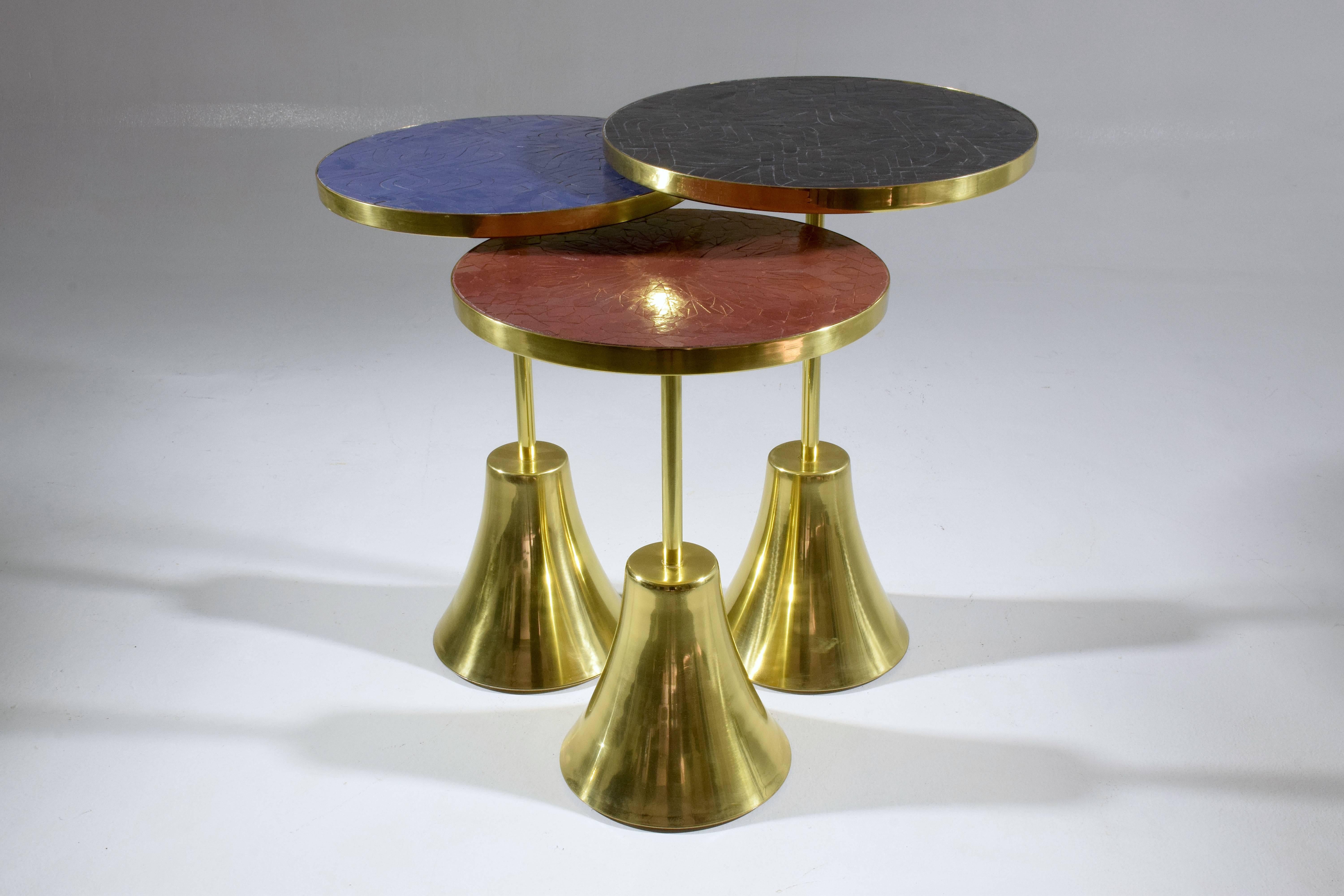 Set of three contemporary handcrafted guéridon side or end nesting tables composed of a solid brass structure and designed with two intricate mosaic tile tabletop zellige designs handmade with expert workmanship by Moroccan artisans. This set of