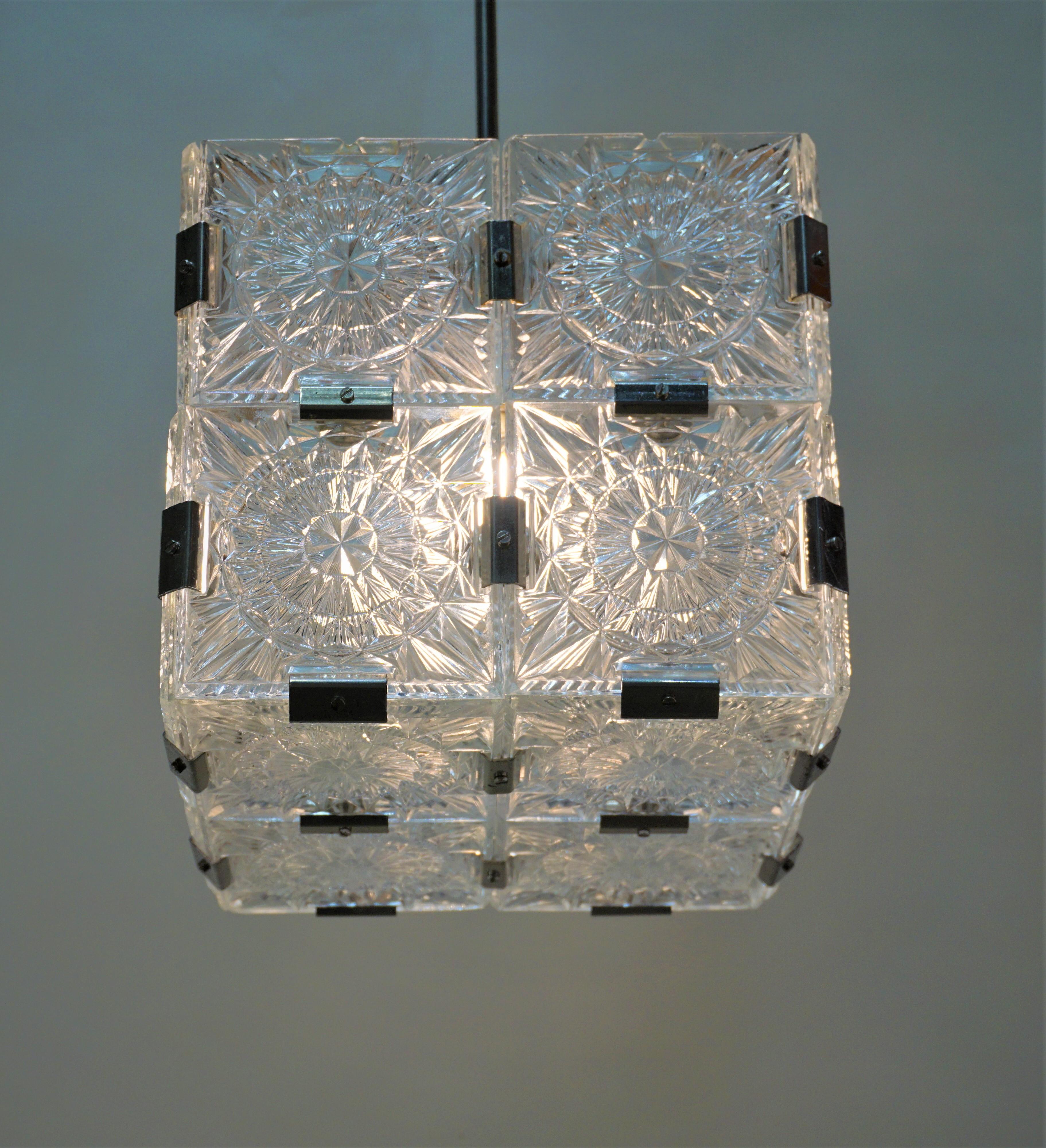 Modernist square cubic chandelier consist of four pieces of glass that formed together by brackets. These pendant lights are made by the famous crystal Lorenz Brothers (Kamenicky Senov), Prague Art and Design glass.
Measurement is 9.5