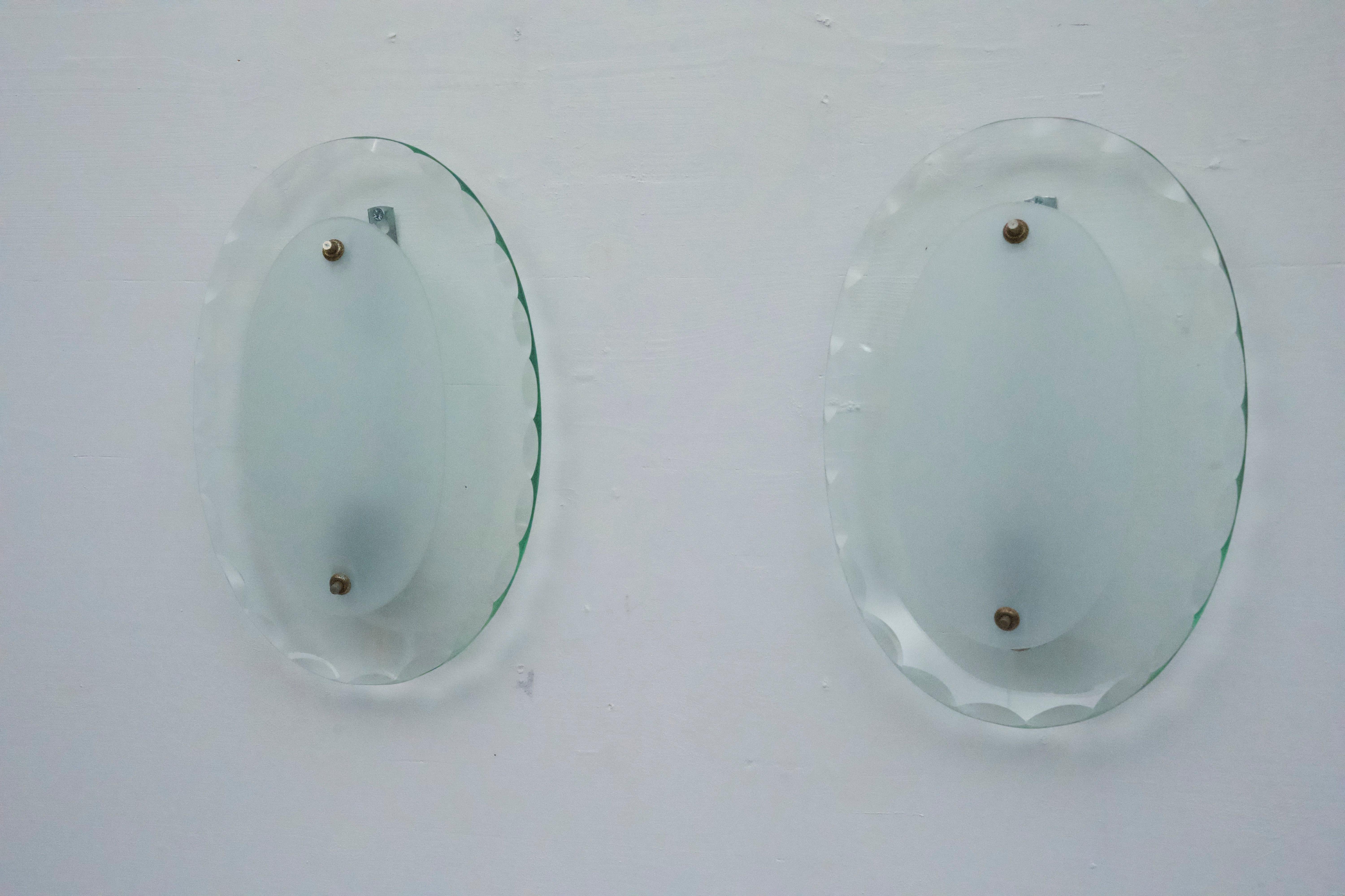 This set of three sconces, crafted by Cristal Art in the 1960s, features elegant curved glass. The pieces are in excellent vintage condition, with no chips or cracks.Full working with EU standard, adaptable on demand for USA standard.