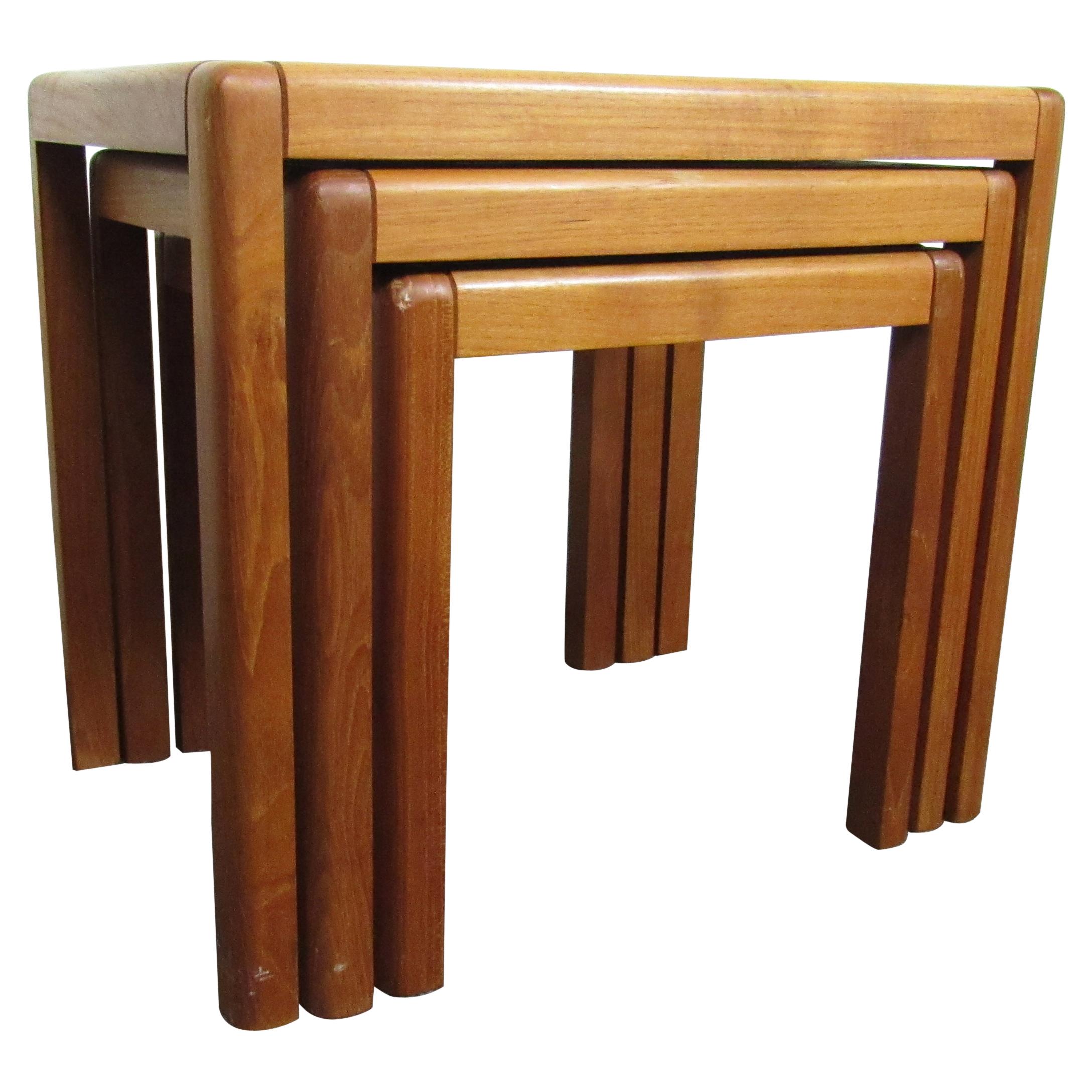 This set of three Mid-Century Modern nesting tables show off a rich teak woodgrain complemented by tile inlays. Made in Denmark. Please confirm item location with seller (NY/NJ).