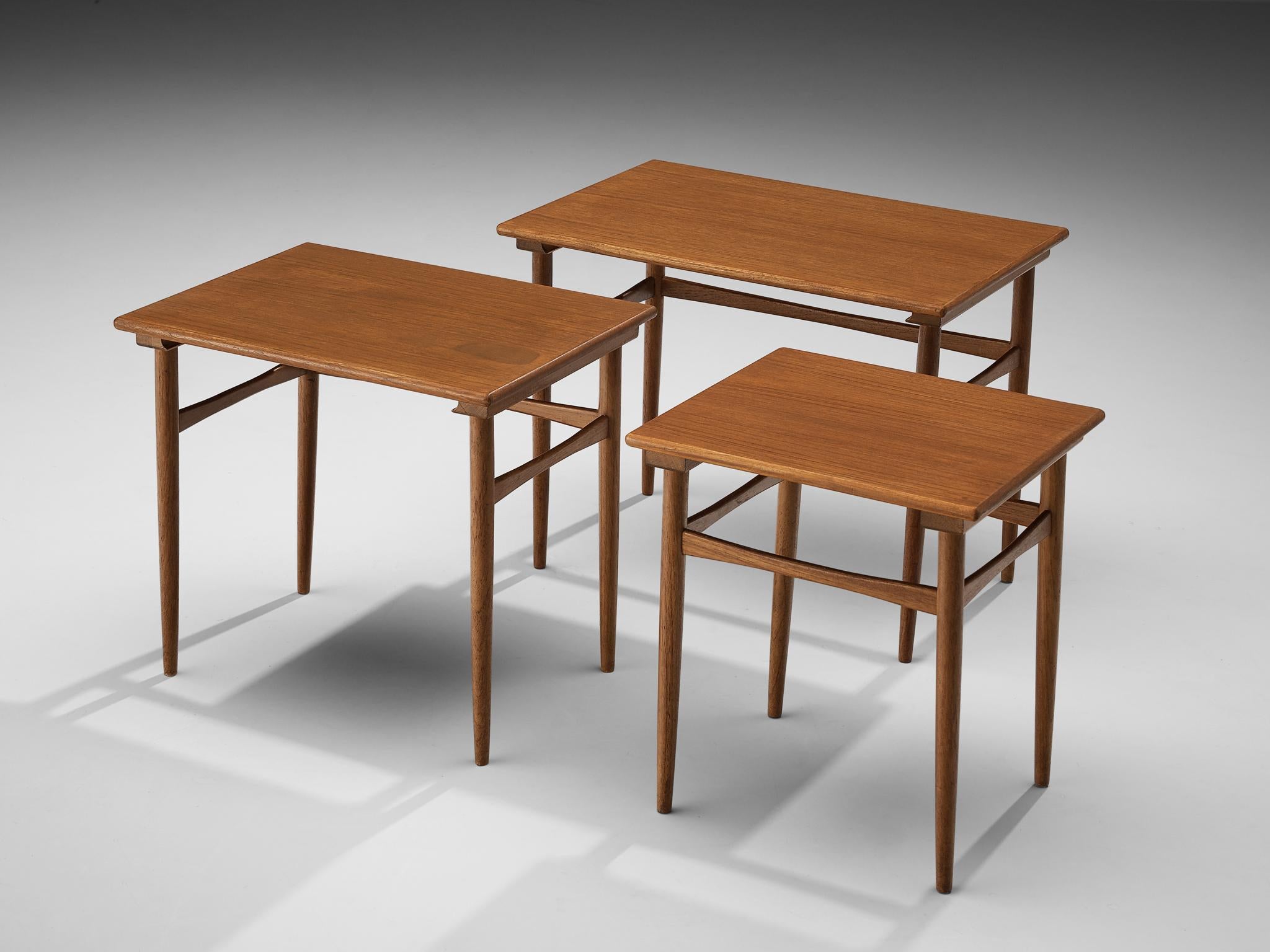 Set of three Danish nesting tables, teak, Denmark, 1950s.

Danish set of three nesting tables executed in teak. The three tables not only differ in their height but also in the format of the tops. Whereas the tallest table has a rectangular format,