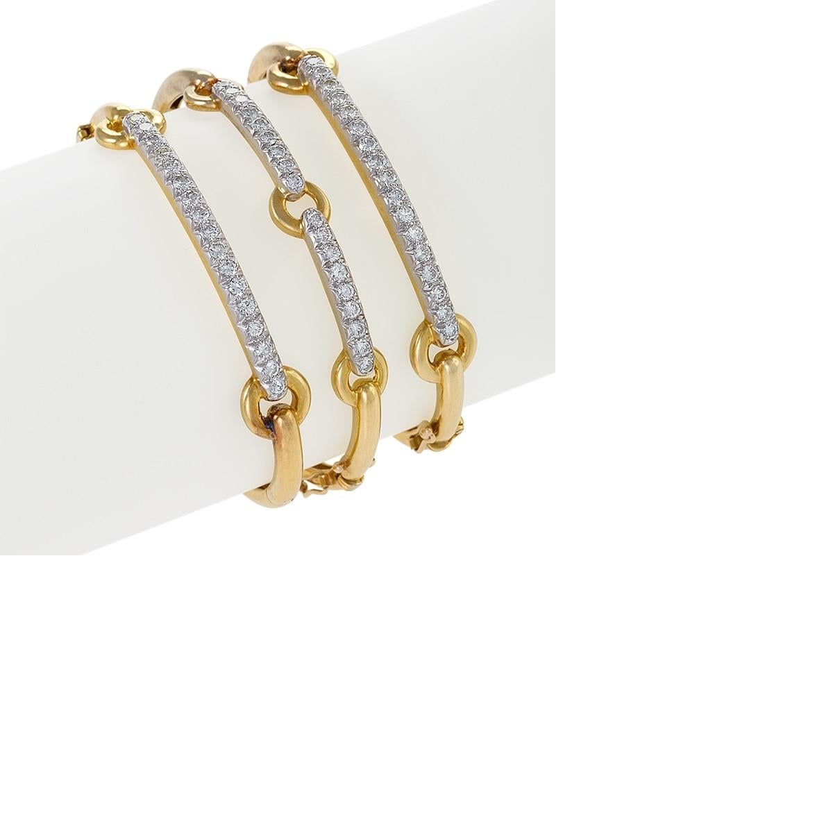 A set of three American modern 18 karat gold and platinum bangle bracelets, set with round brilliant-cut diamonds, with an approximate total weight of 3.75 carats, by David Webb. The diamonds have a G-H color and VS clarity grade. 

This stylish set
