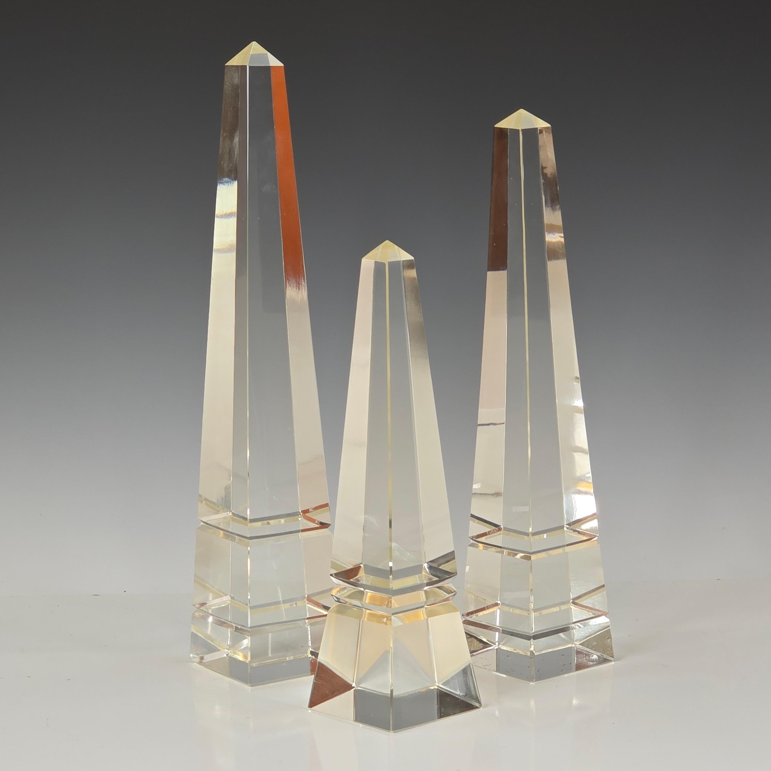 A striking trio of solid cut crystal obelisks in graduated sizes, dating to the 1960s. These sculptural forms are precision-cut with gleaming facets that reflect and refract light beautifully—creating a dynamic presence in any interior.

The