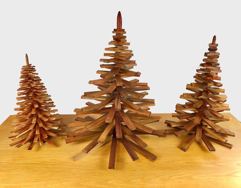 Set of three decorative handmade Christmas trees.

The Christmas trees are made of upcycled pieces of oiled teak from a furniture manufactorer that would normally be handled as waste - each Christmas tree is because of this uniqe why variation in