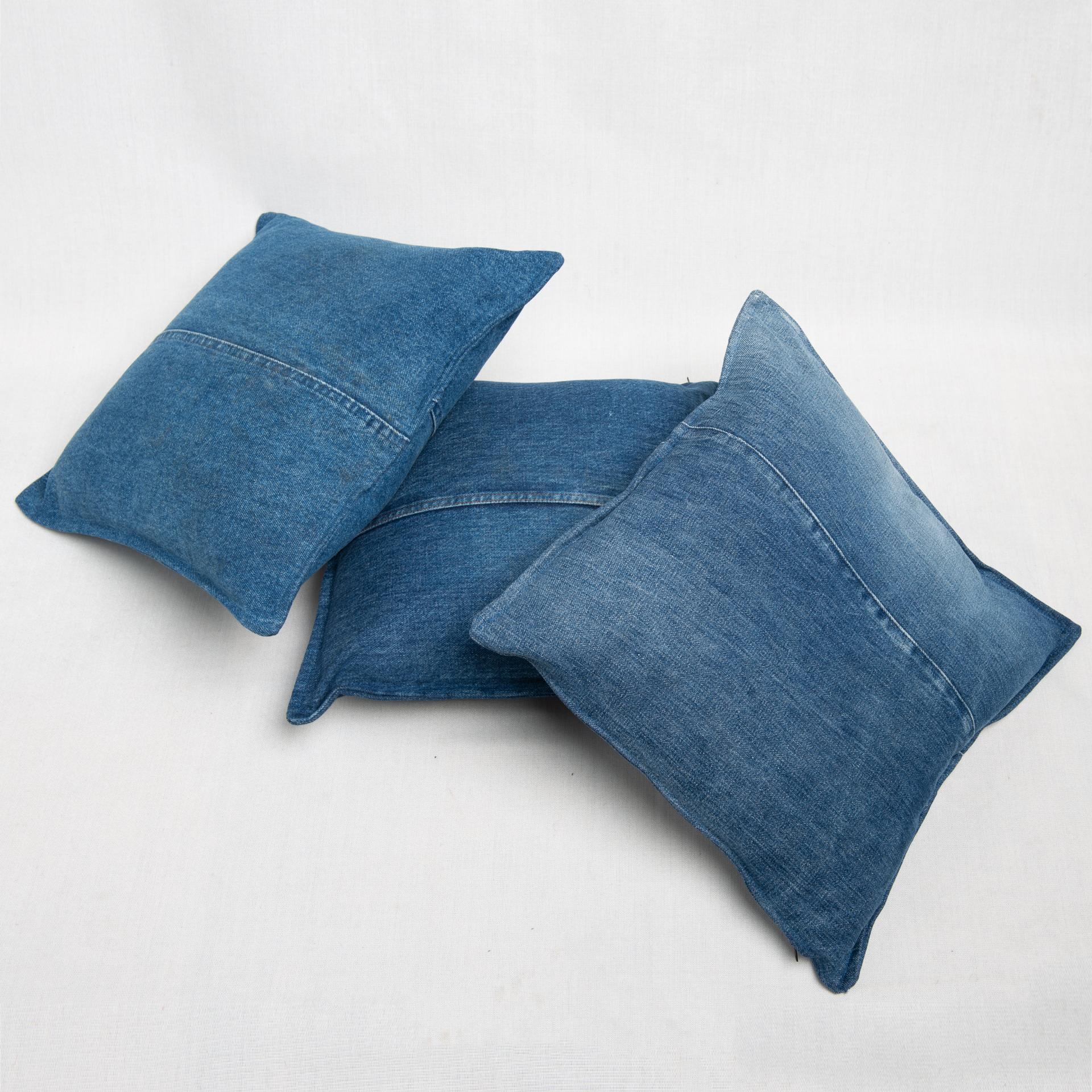 Unusual set of three pillows in old denim fabric with center seam. 
Do You like my idea ?
They are in different sizes but it is not noticeable because they are casual.
 
