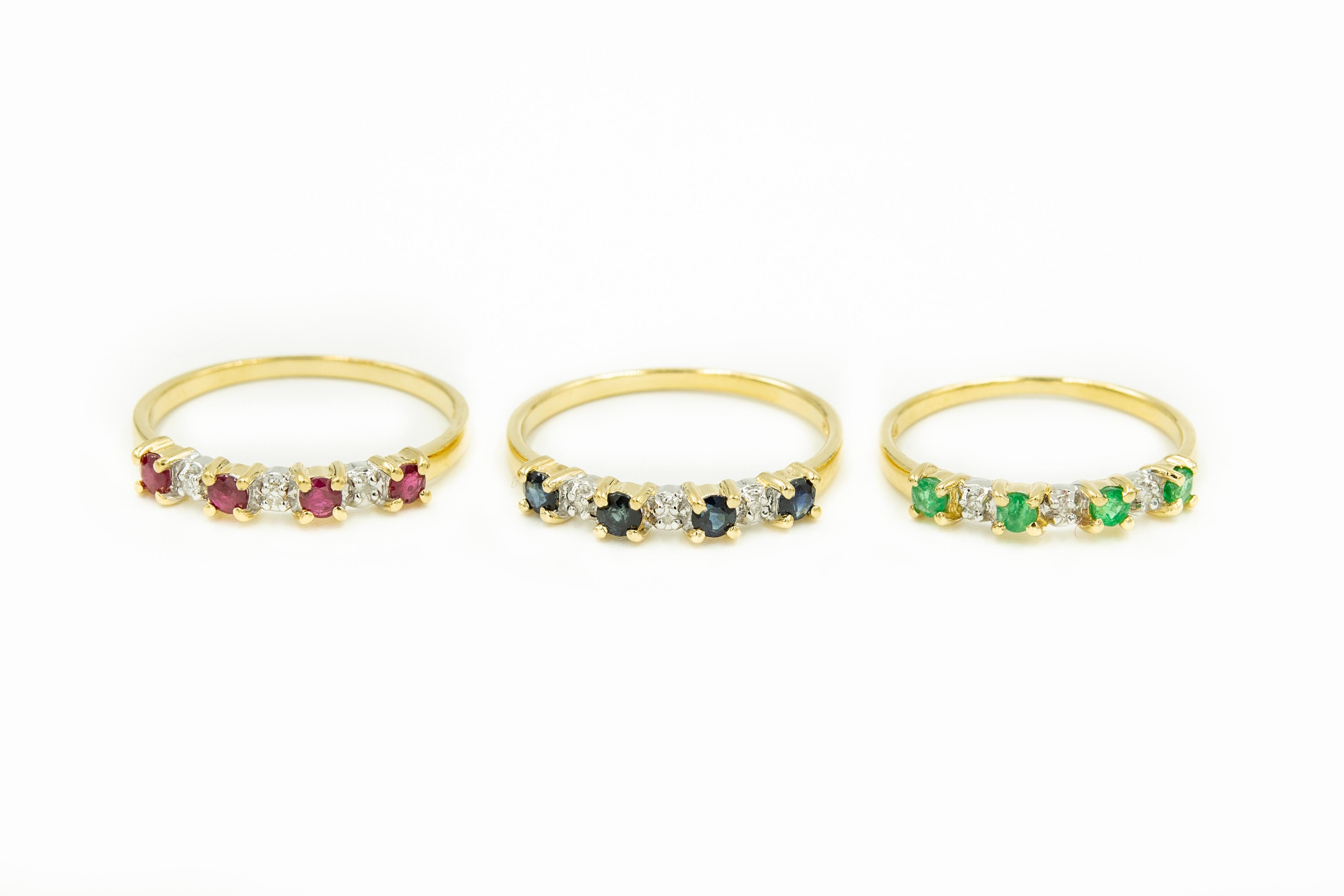 Set of 3 -  14k yellow gold stacking rings that each contain 4 faceted gemstones and 3 single cut diamonds.  One has rubies, another has sapphires and the last one has emeralds.  They can be worn as a set or separately.  Measurements below are for