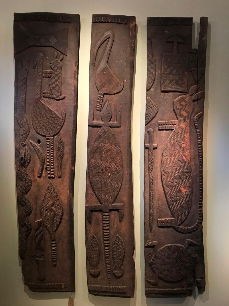This set of three early twentieth-century panels, from the Nupe culture in Nigeria, display a blend of beautiful decorative designs, carved in low relief against a plain background. Interspersions of stylised animals - from lizards, turtles and