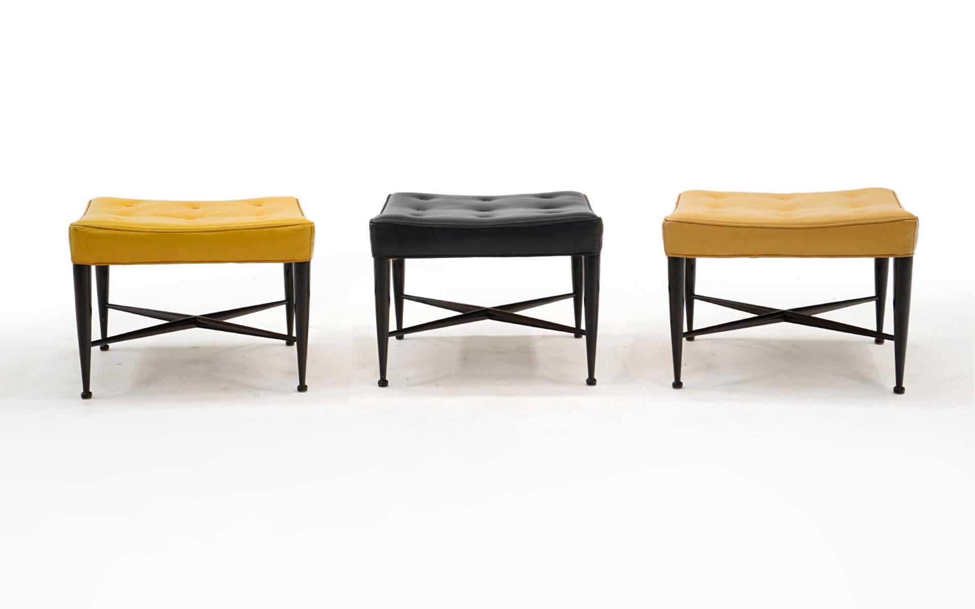 Rare set of three completely original, one owner, x base Thebes Stools designed by Edward Wormley and manufactured by Dunbar, 1950s.  Signed with the Dunbar metal tag.  Three colors of leather: yellow, muted yellow and charcoal.  The yellow example