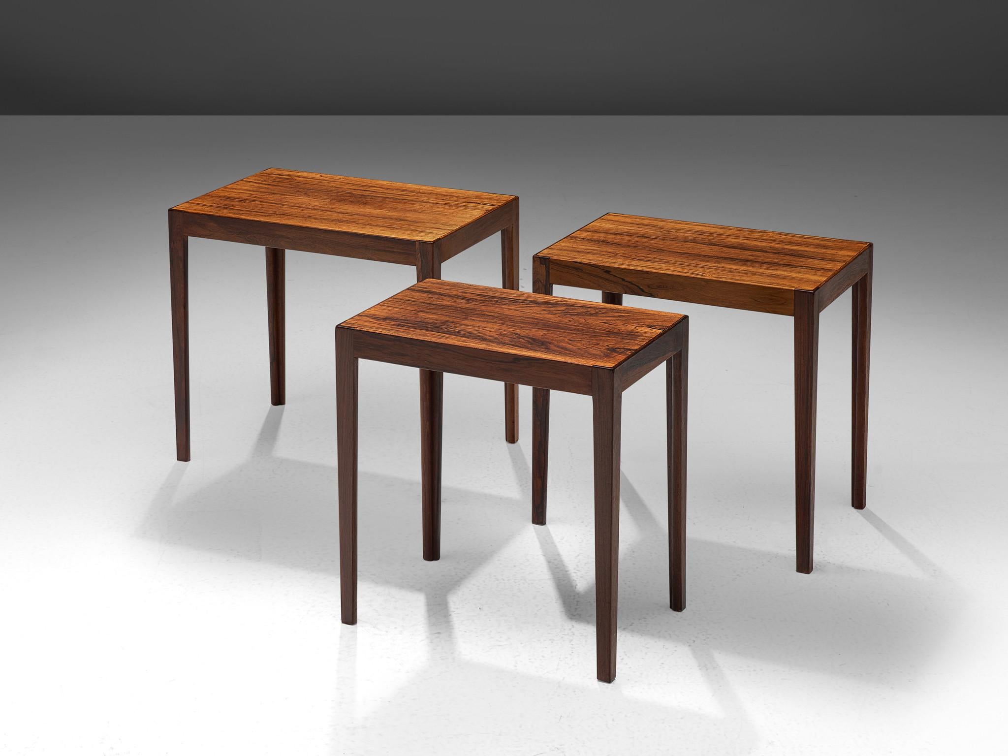 Nesting tables, in rosewood, The Netherlands, 1960s.

Nest of three tables is rosewood. With a tight base of slats, beautifully connected with wood joints. The rectangular top has a nice trim which emphasize the grain of the rosewood, the legs are