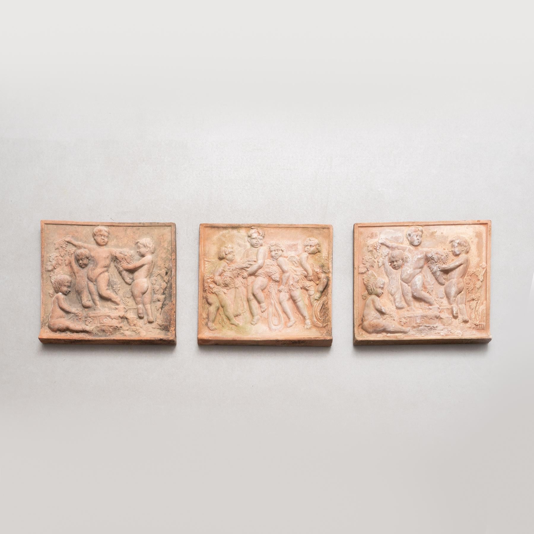 Enhance your collection with this exquisite set of three early 20th century terracotta wall sculptures, manufactured in Spain circa 1940. These captivating pieces, in their original condition, showcase the remarkable artistry and craftsmanship of