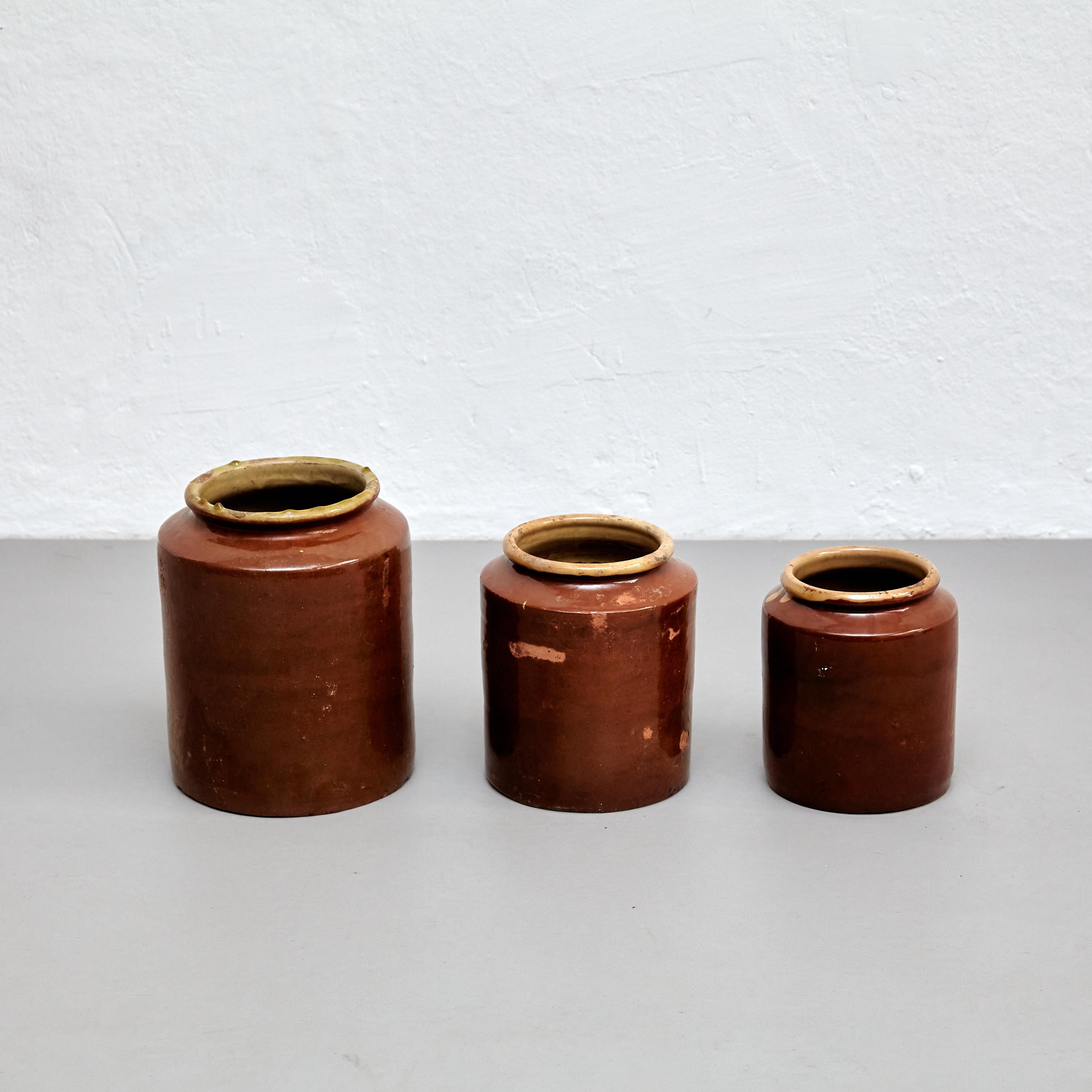 This set of three rustic ceramic vases is a beautiful example of early 20th-century Spanish craftsmanship. Each piece was carefully handmade and features a unique, organic shape that highlights the natural beauty of the ceramic material.