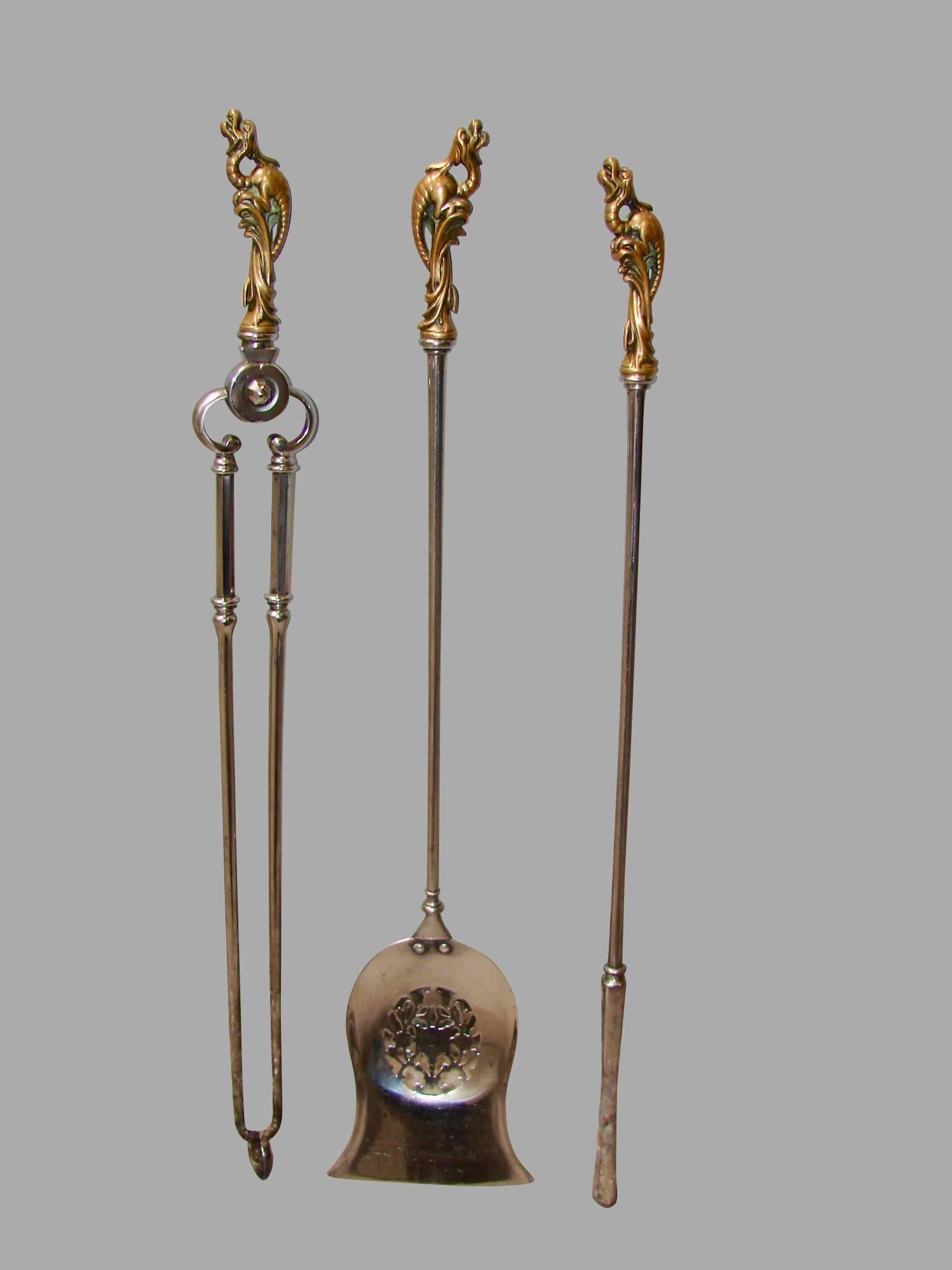 A fine quality set of English polished steel bronze handled fire tools of large size consisting of a poker, shovel and tongs, each tool with a fanciful bronze handle in the form of a mythological creature, circa 1840.