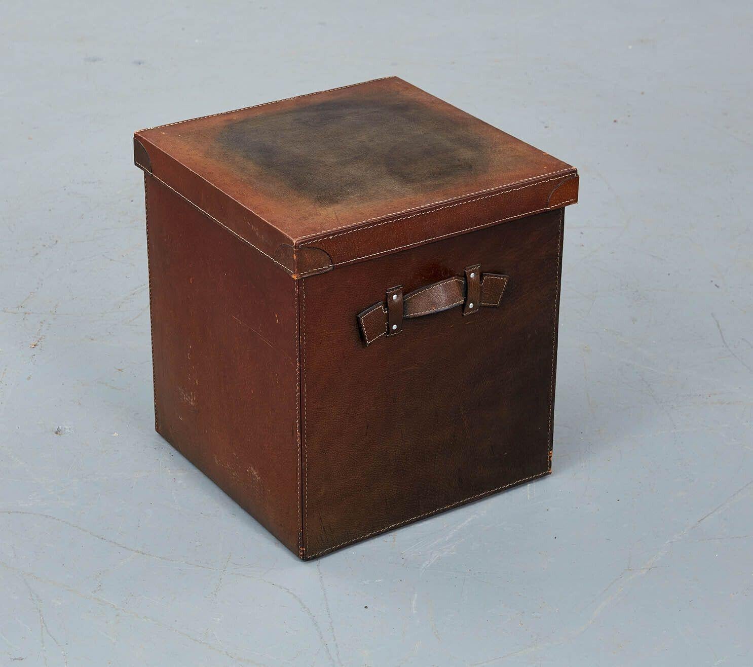 A set of three English nesting leather dispatch boxes with lids and leather handles to sides, suitable for use as drinks tables next to chairs and sofas. Silk pockets sown into underside of tops. Also useful for storage of valuables.