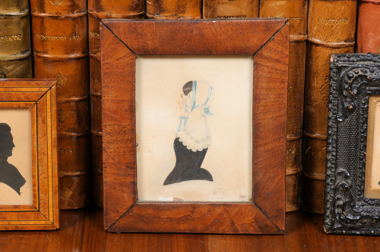 A set of three English Victorian period framed wooden silhouette miniatures from the 19th century, depicting a woman, a poet and a musician. Created in England during the Victorian era, this set of three framed miniatures features lady depicted in
