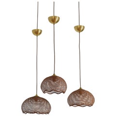 Set of Three English Woven Rattan Pendant Lights, 20th C.
